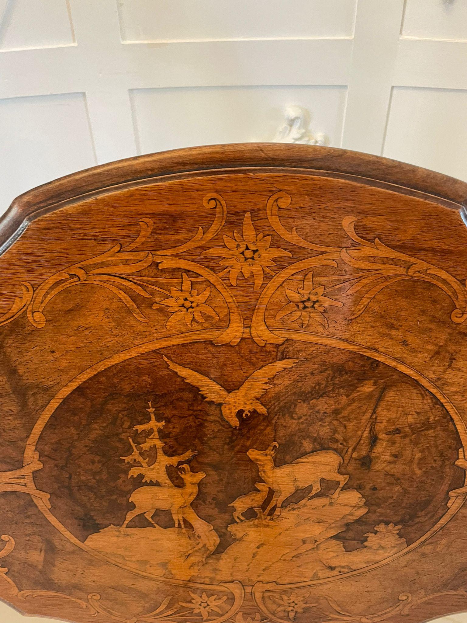 Unusual Antique Victorian quality marquetry inlaid walnut Swiss Black Forest table having a fantastic quality burr walnut marquetry beautifully inlaid serpentine shaped tilt top with decorated panels of mountain deer, lbex birds and foliage,