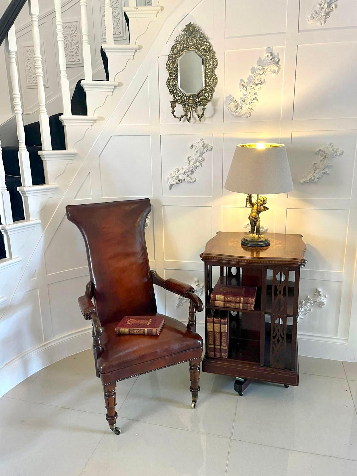 Unusual antique quality William IV leather and mahogany library chair having a newly reupholstered seat and back in a quality chestnut colour leather, shaped open arms with turned supports standing on shaped tulip tapering legs to the front and out