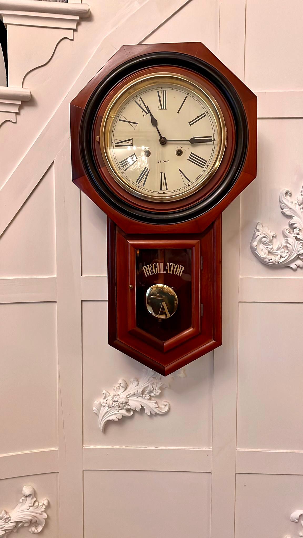 Unusual antique Victorian 31 day regulator wall clock having a circular glazed door with brass bezel enclosing white dial with Roman numerals and original hands, twin train movement, a smaller glazed door below, original pendulum and key.

In