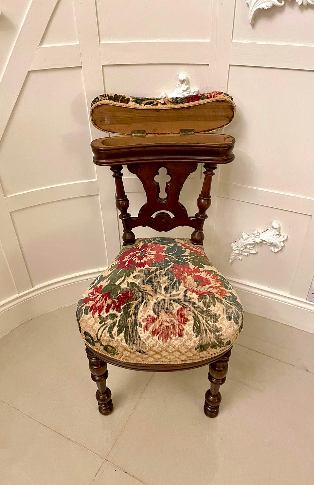 Unusual antique Victorian oak side chair having an upholstered lift up top to reveal a storage compartment above a shaped carved centre splat supported by turned columns. It boasts a pretty shaped seat and stands on four turned legs. 

We are able