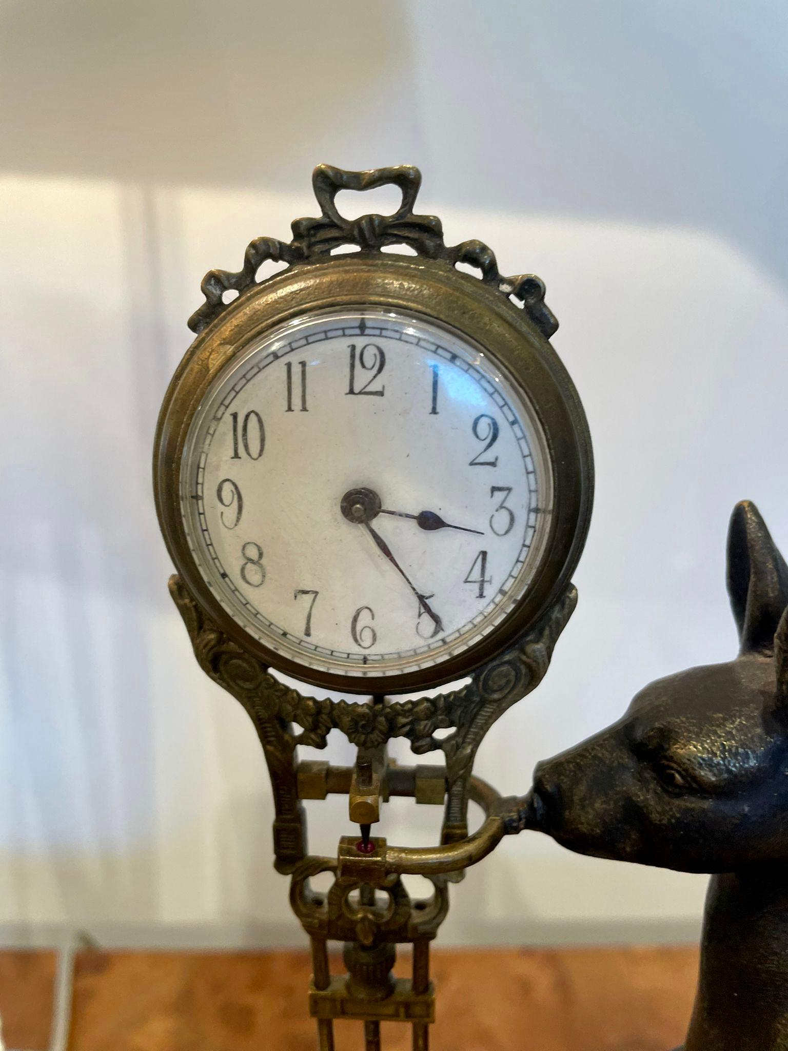 Unusual Antique Victorian quality bronze novelty desk clock having a quality bronze model of a kangaroo holding a swinging clock with a circular porcelain dial and an ornate brass pendulum. It stands on a shaped walnut base with a thumb moulded edge
