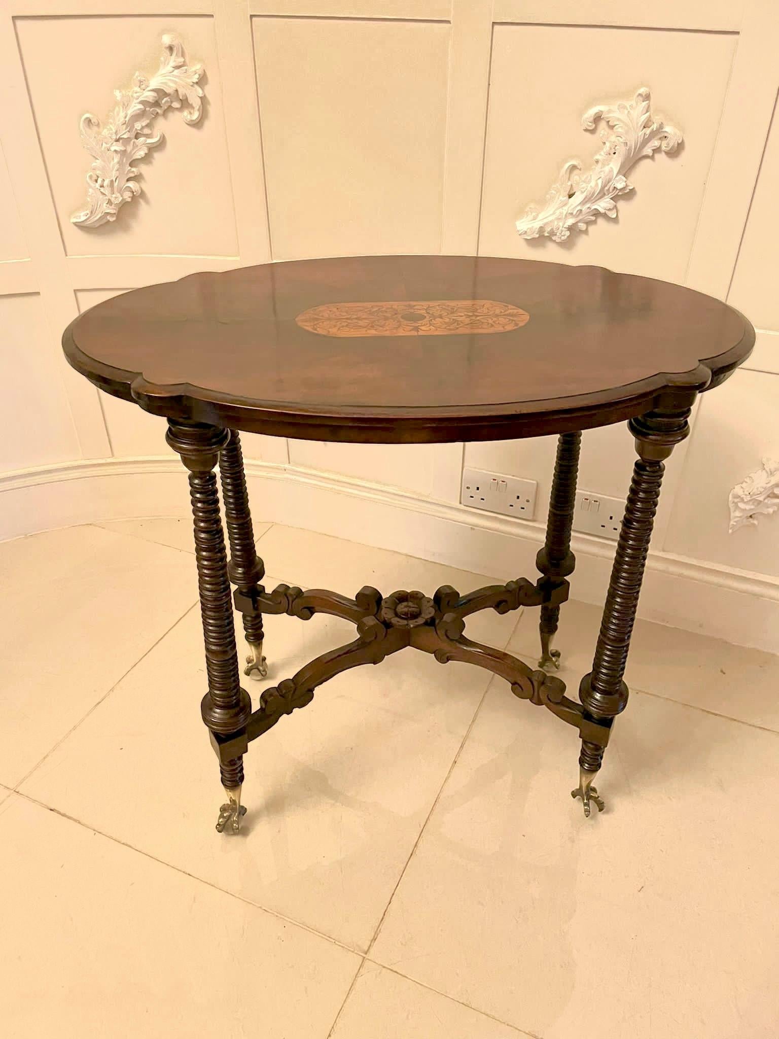 Unusual Antique Victorian quality burr walnut inlaid lamp table having a quality attractive shaped burr walnut marquetry inlaid top with a moulded edge, pretty shaped frieze supported by four solid walnut bobbing turned columns with unusual brass