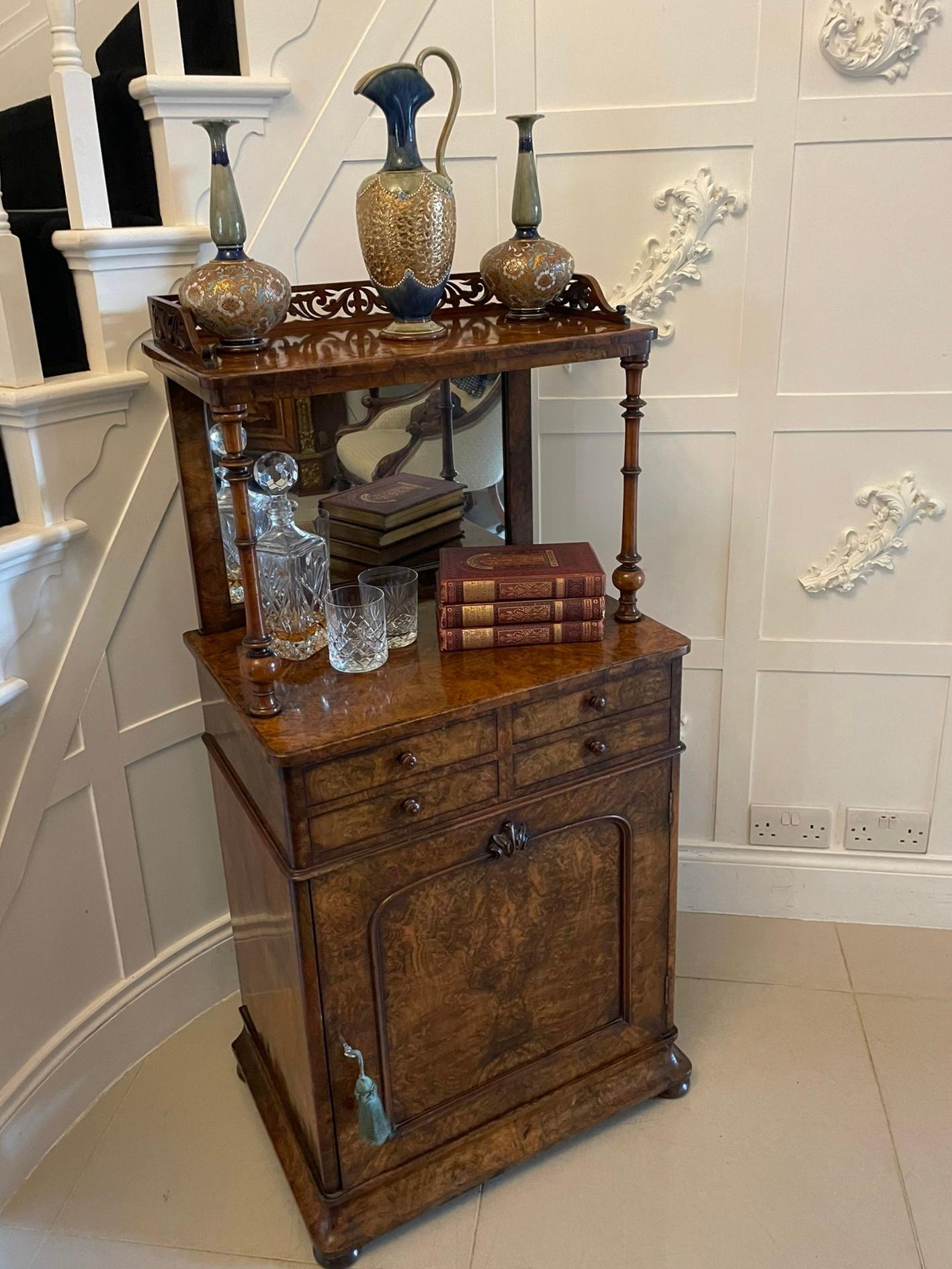 Unusual Antique Victorian quality burr walnut side cabinet having a carved walnut gallery above a burr walnut top supported by a mirror back and a pair of turned walnut columns, four small drawers with original turned walnut knobs above a single
