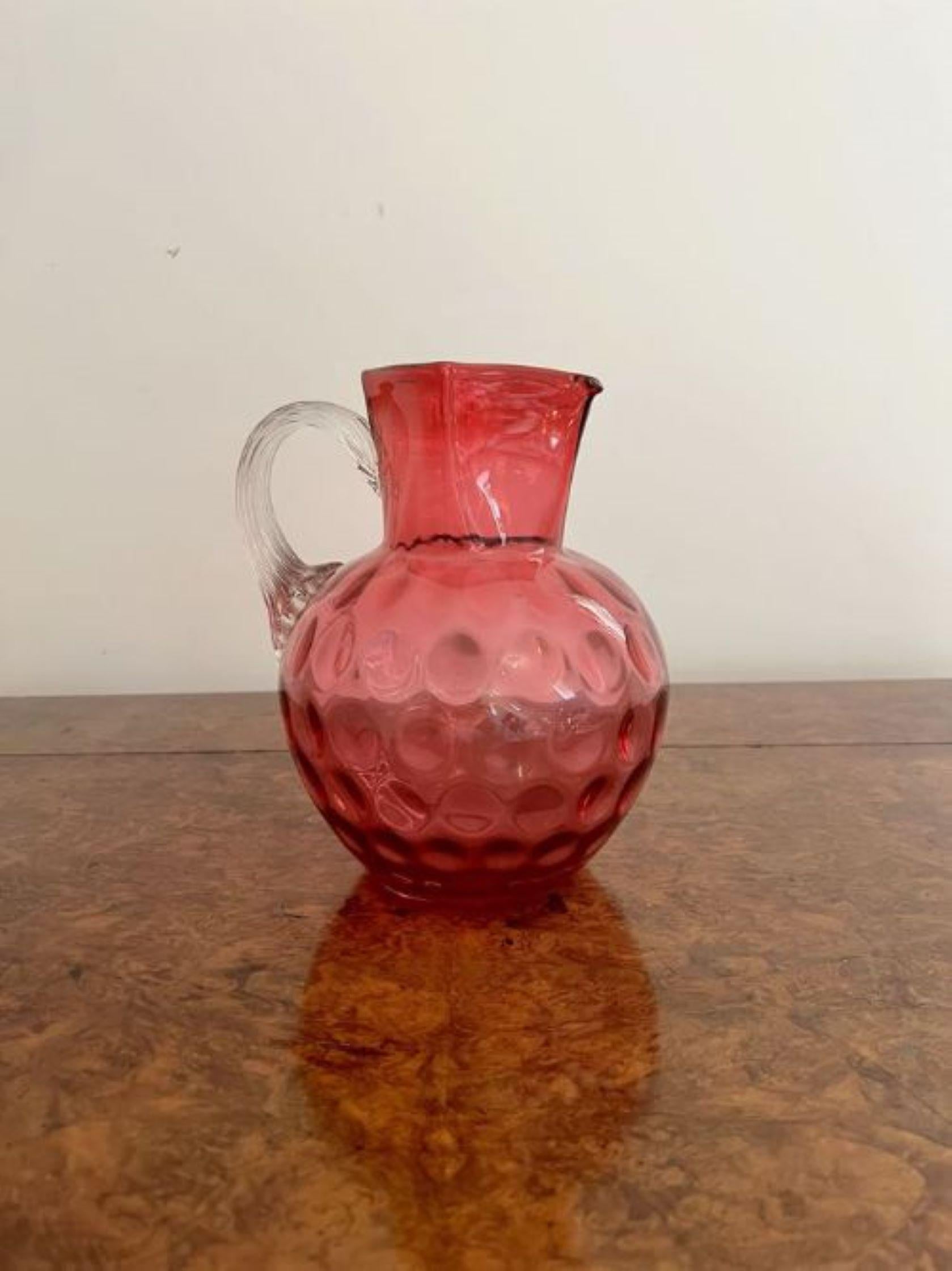 Unusual antique Victorian quality cranberry glass jug having an unusual square shaped top and a shaped handle to the back.