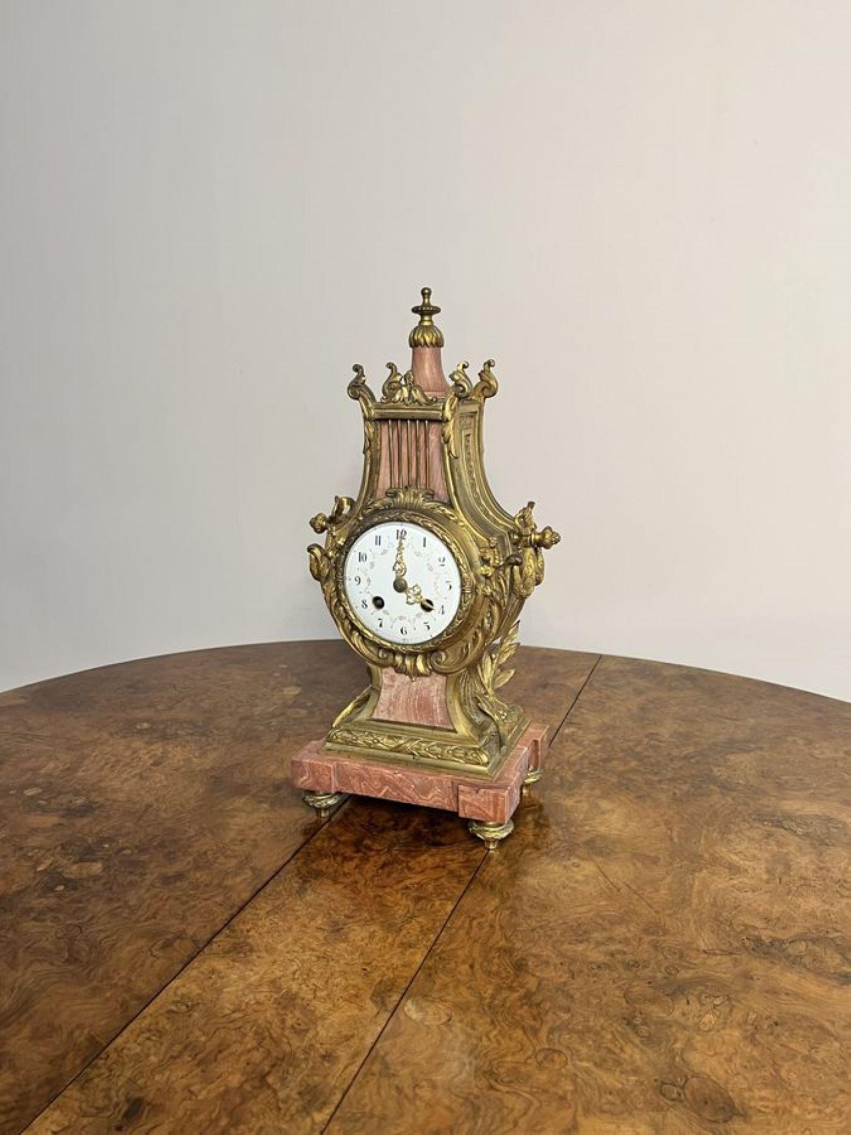 Unusual antique Victorian quality French mantle clock, having an unusual shaped ornate gilded metal and pink marble case decorated with finely cast scroll and bow decoration, standing on four original ornate feet, pretty hand painted porcelain dial
