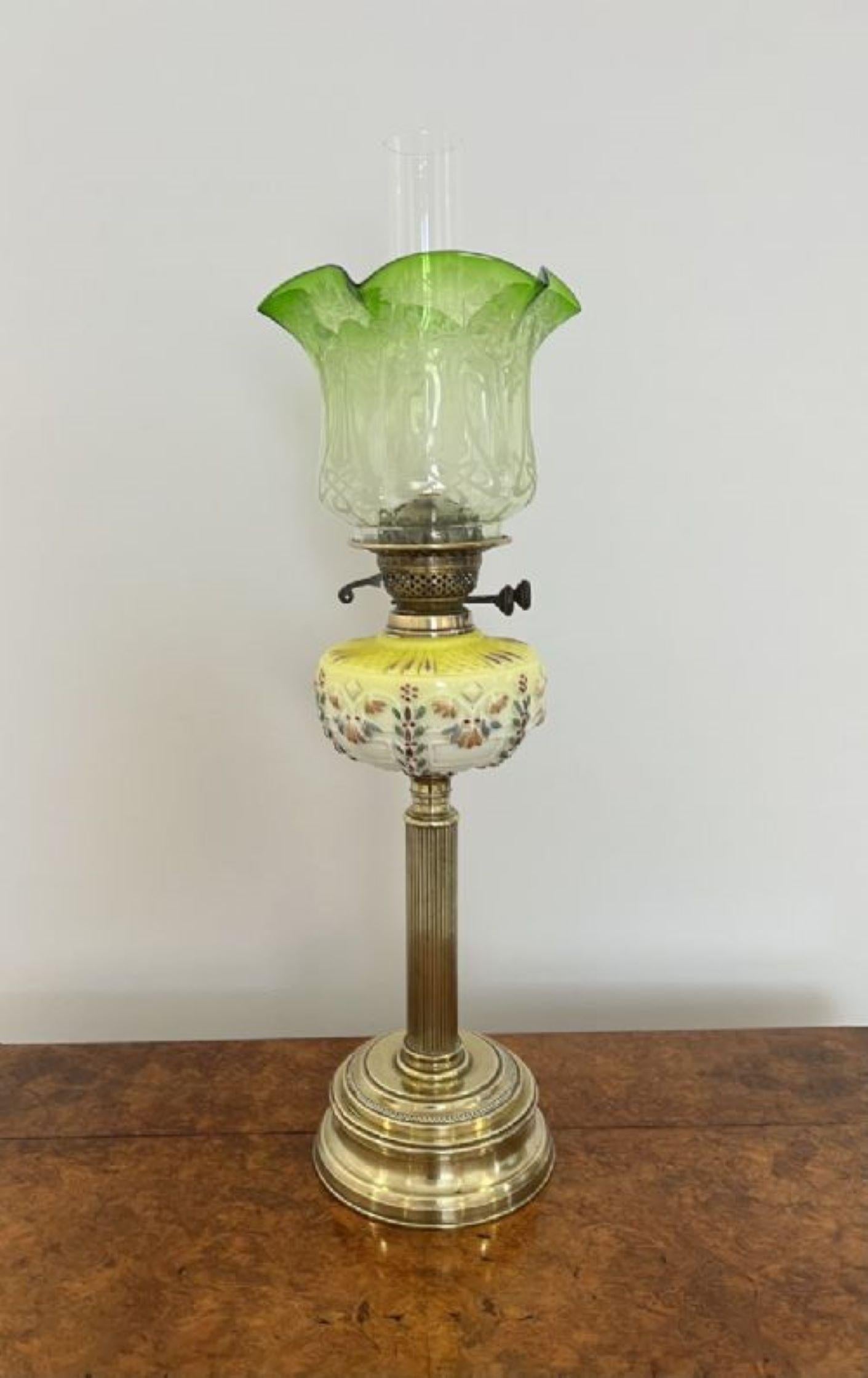 Unusual antique Victorian quality glass and brass oil lamp having a quality unusual Victorian brass and glass oil lamp with a fabulous yellow glass decorated font on a fluted brass column standing on a circular base with a green glass shaped shade. 