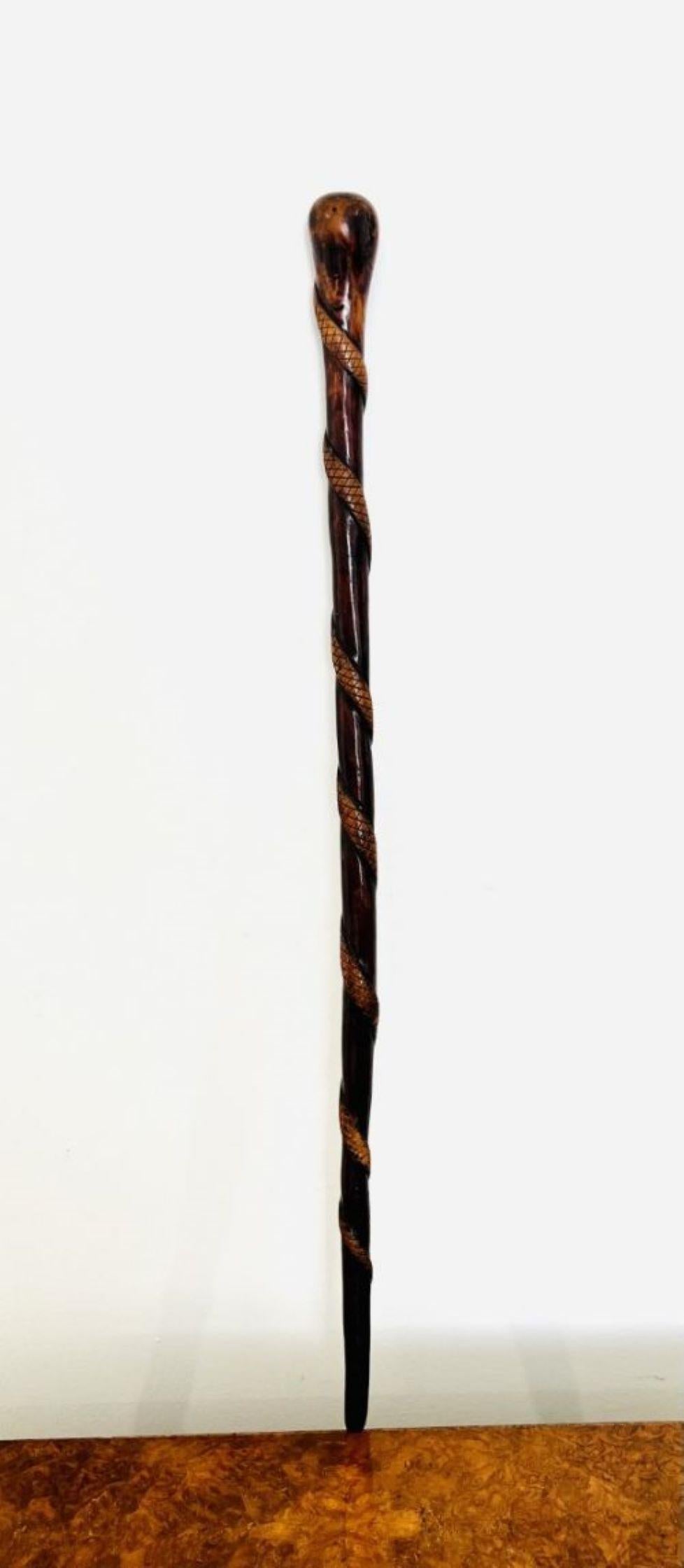 Unusual antique Victorian quality hardwood walking stick having an unusual quality hardwood antique Victorian walking stick with a carved snake wrapped round it. 