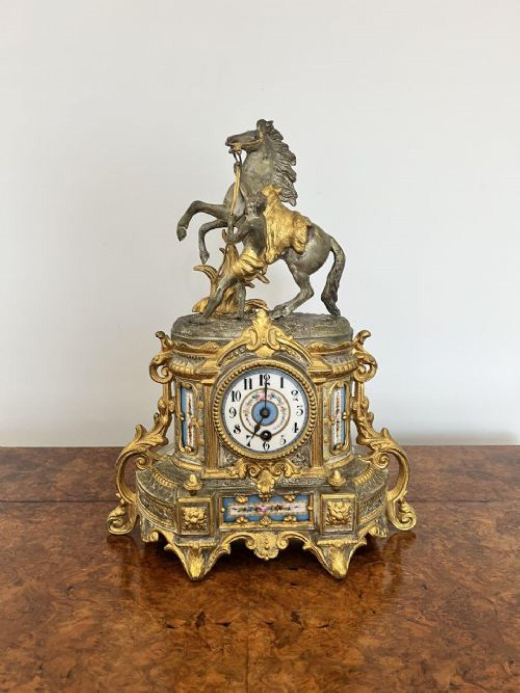 Quality antique Victorian gilded timepiece with beautiful porcelain detail having a quality antique Victorian timepiece with wonderful ornate decoration throughout with a horse and rider mounted to the top, having porcelain decorated panels to both