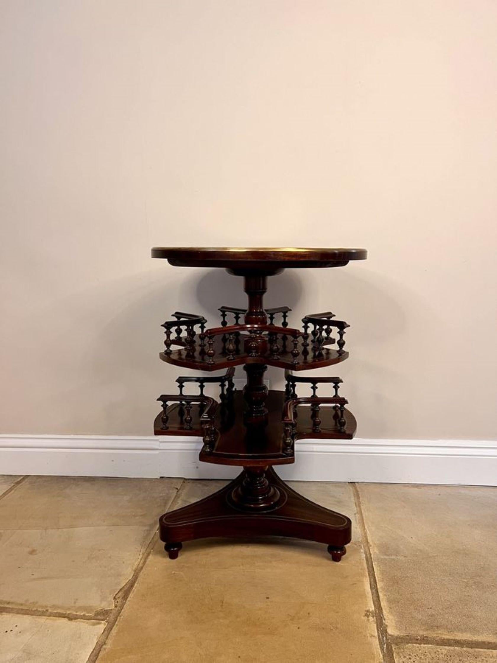 Unusual antique Victorian quality mahogany brass inlaid marble top revolving book table, having a quality circular mahogany brass inlaid top with a marble centre supported by a turned column, double shaped revolving book shelves with turned spindles