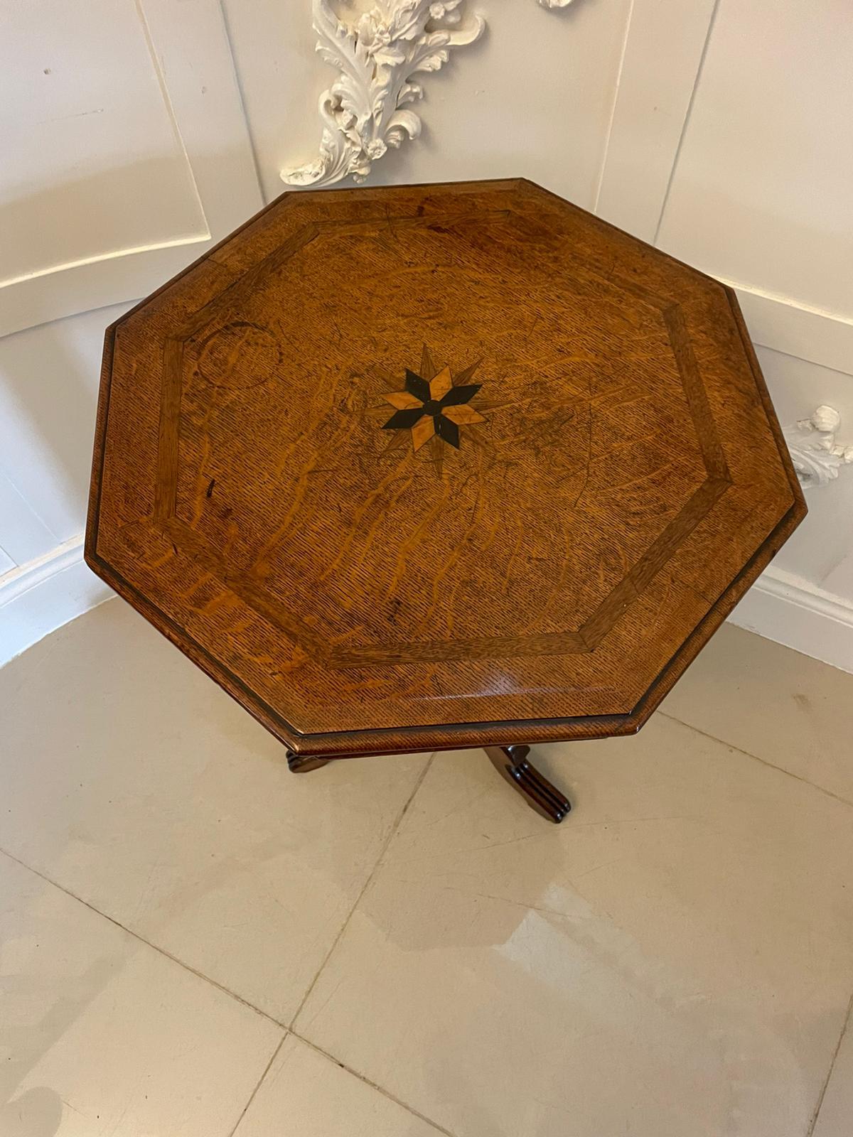 Unusual Antique Victorian quality oak lamp table having a hexagonal quality oak top with a thumb moulded edge, pretty inlaid star burst to the centre supported by a reeded pedestal column standing on shaped reeded cabriole legs. 

An attractive