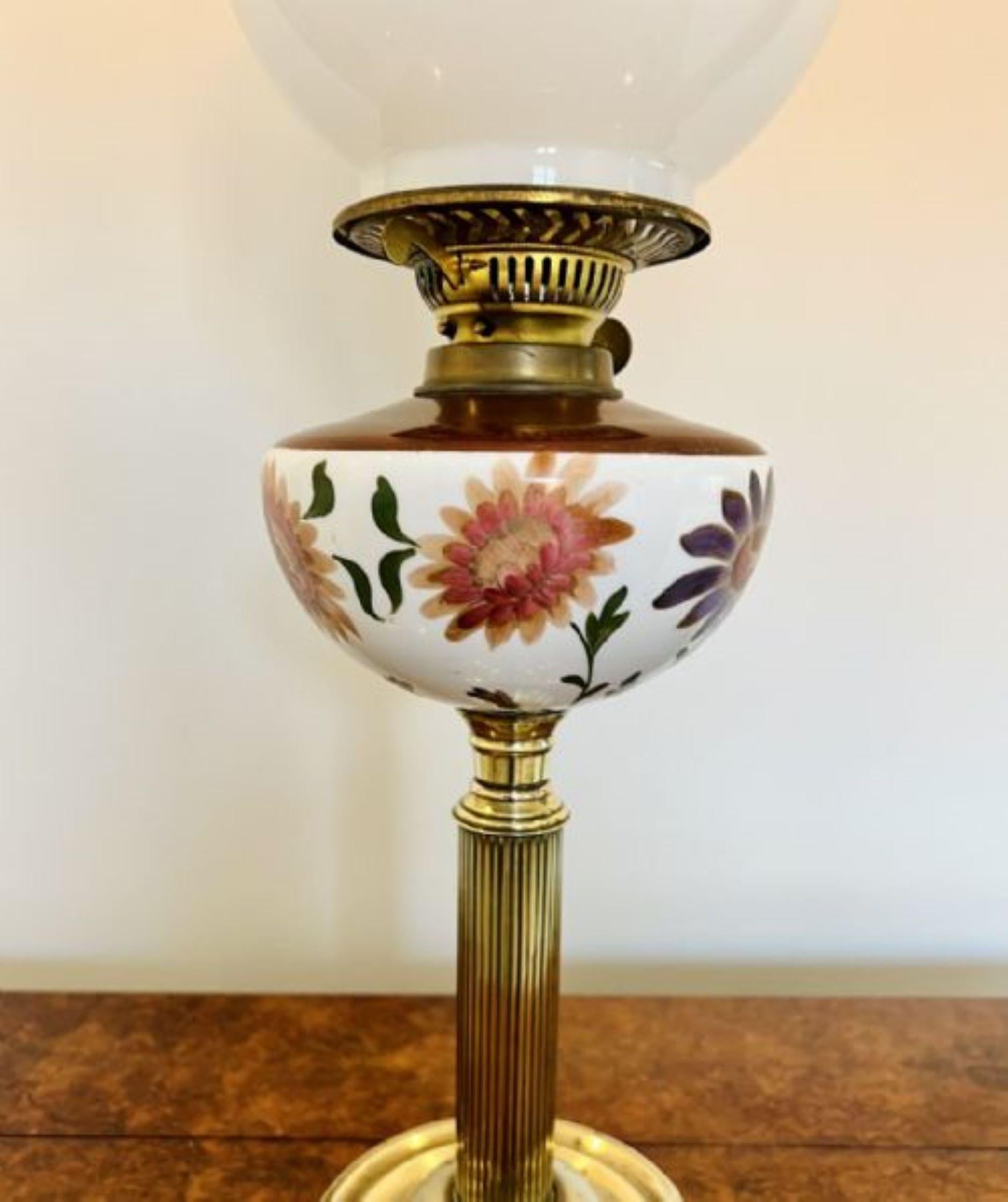 Unusual antique Victorian quality oil lamp having a quality white glass shade, with a brass double burner, unusual hand painted porcelain font with a wonderful floral decoration in green, purple and red colours, supported on a brass column raised on