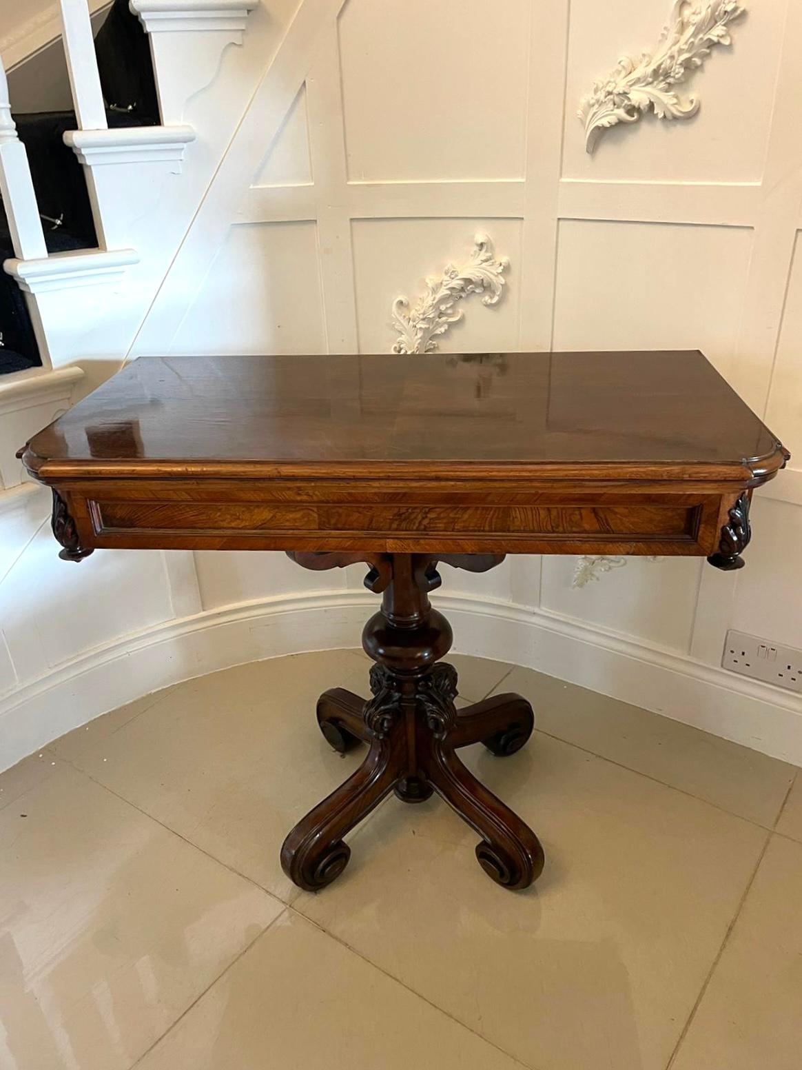 Unusual antique Victorian walnut card/side table having a lovely walnut swivel top, green baize interior and attractive carvings to the frieze. It boasts a delightful turned carved column. It stands on four carved shaped legs.

This solid walnut