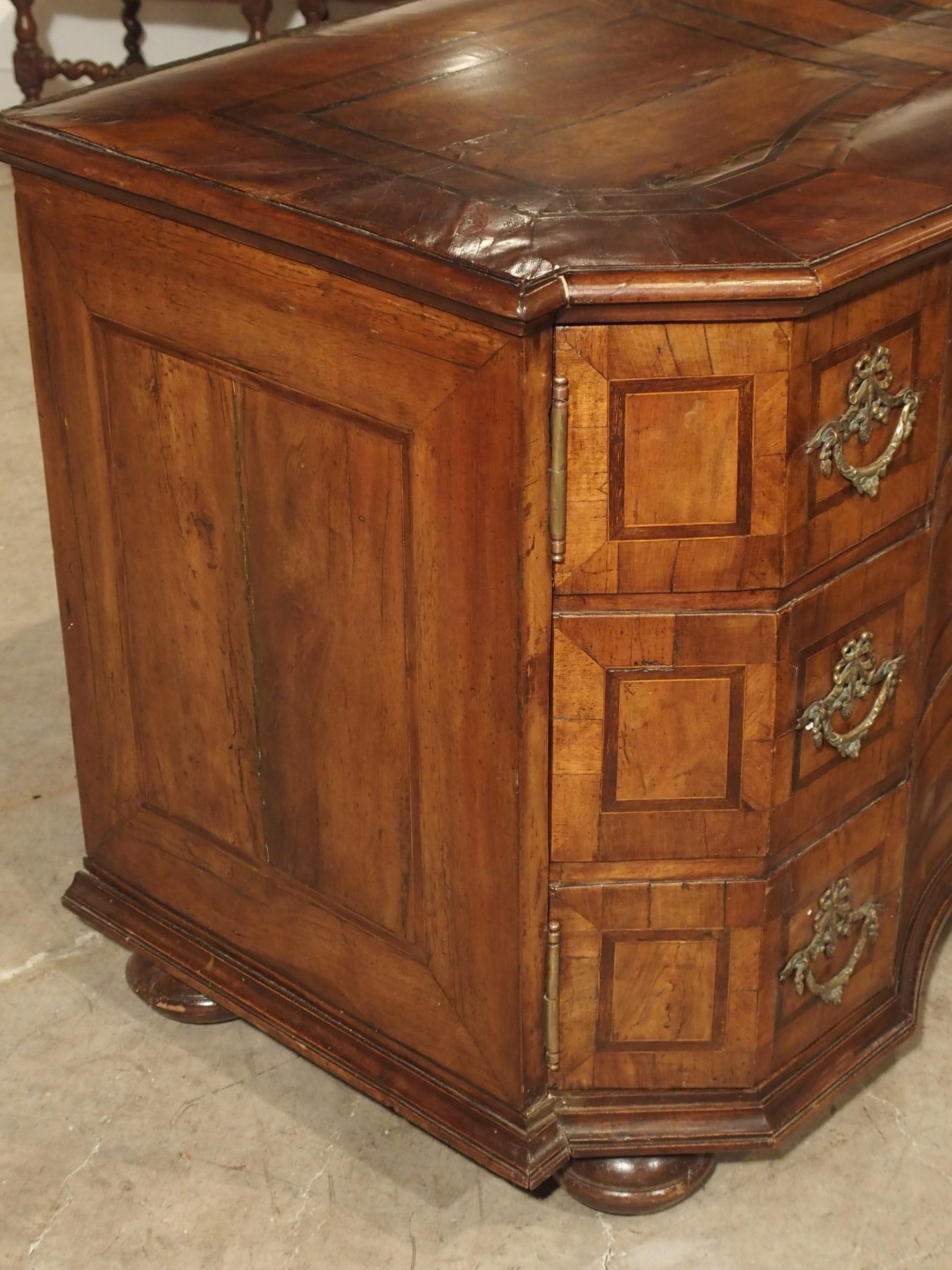 This unique and elegant walnut veneer commode-form buffet is from Southern Germany, circa 1760.

Originally produced as a three-row chest of drawers, a previous owner had the commode repurposed into a two-door buffet. This transformation took