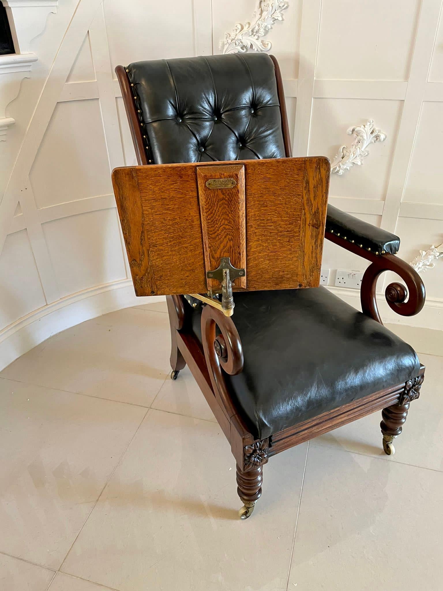 Unusual Antique William IV quality mahogany and leather reclining library chair having a quality mahogany shaped reclining back with scroll shaped mahogany open arms, newly reupholstered deep buttoned back arms, seat and footrest in a quality black