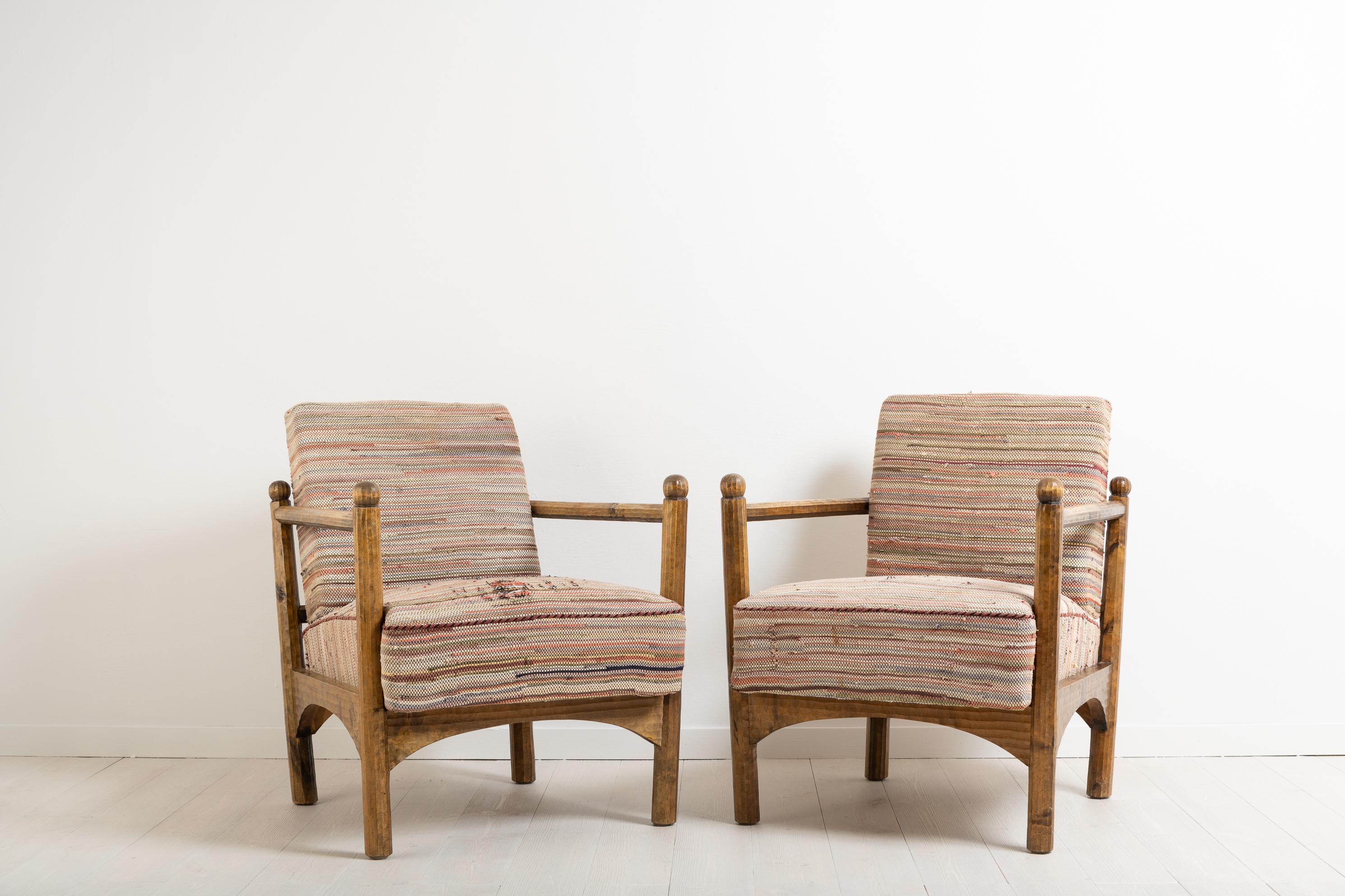 Unusual armchairs Swedish Grace from the 1920s or 1930s. The armchairs are made in a style similar to that of Swedish designer Axel Einar Hjort. Frame in stained birch and hand worked finish. Loose cushions with the original upholstery, the fabric