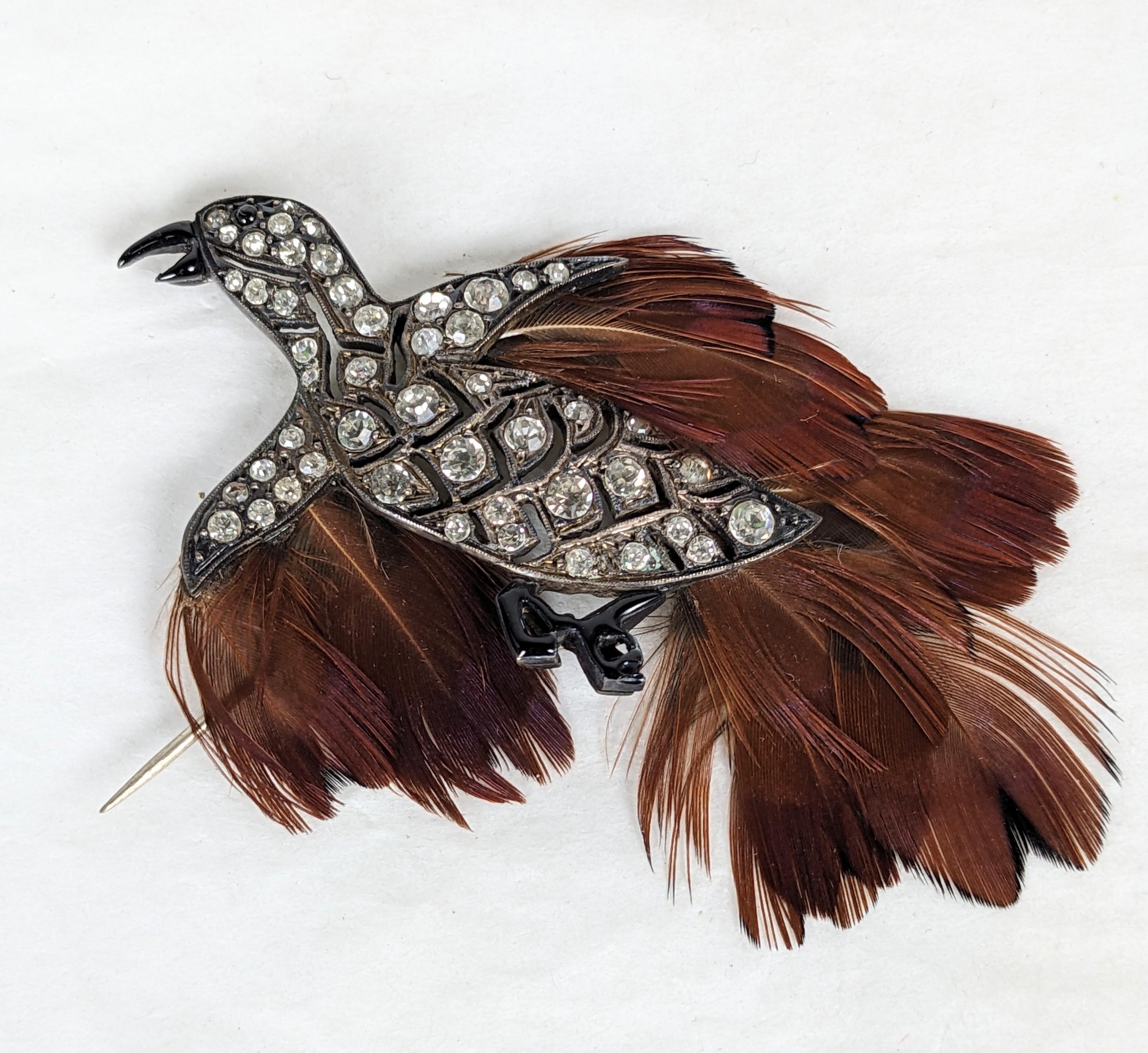 Unusual Art Deco French Paste Bird designed as a stickpin with genuine feather decoration. Hand set paste sterling bird with black enamel detailing on beak and feet. French sterling hallmarks. 
3