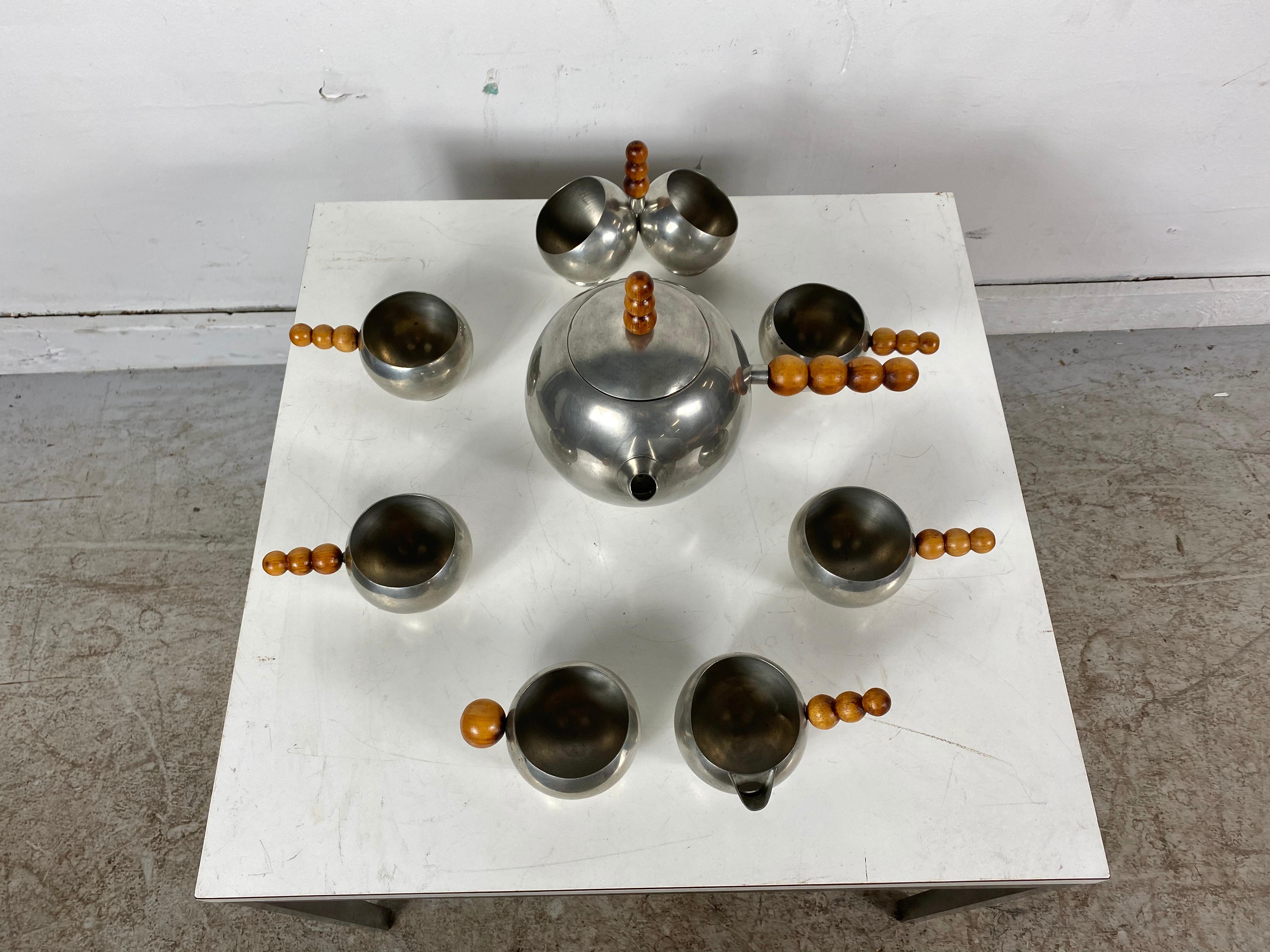 Unusual Art Deco, modernist 8-piece tea set, chrome or wood ball design. Unsigned, stunning modern design, consisting of teapot, creamer and sugar, 4 cups and relish container.