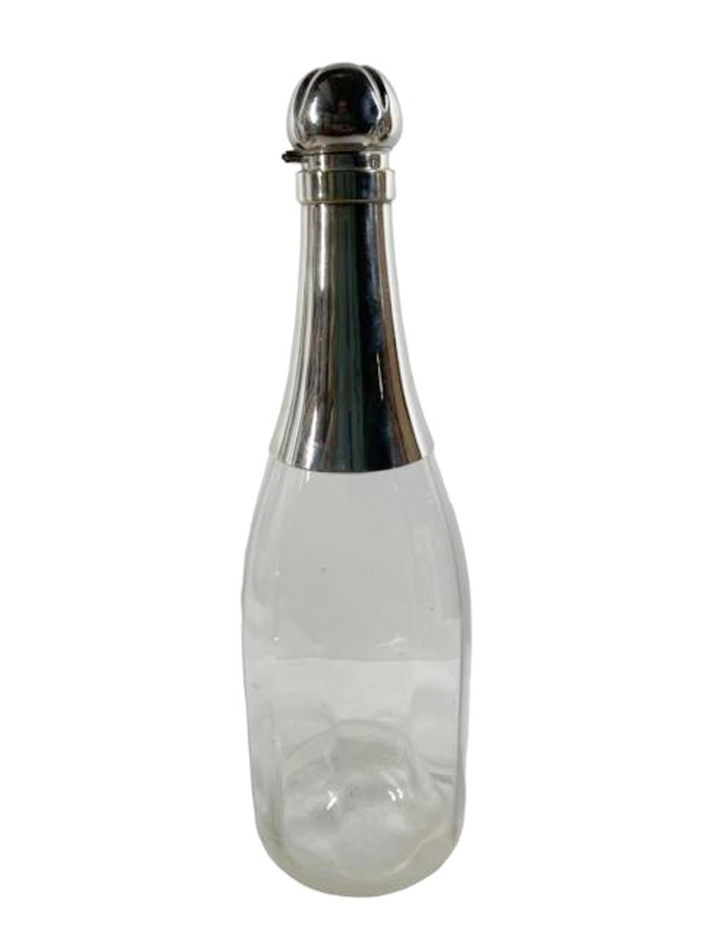 Large Art Deco decanter in the shape of a champagne bottle of optically ribbed clear glass mounted with a silver plate neck and hinged stopper in the form of a champagne cork.