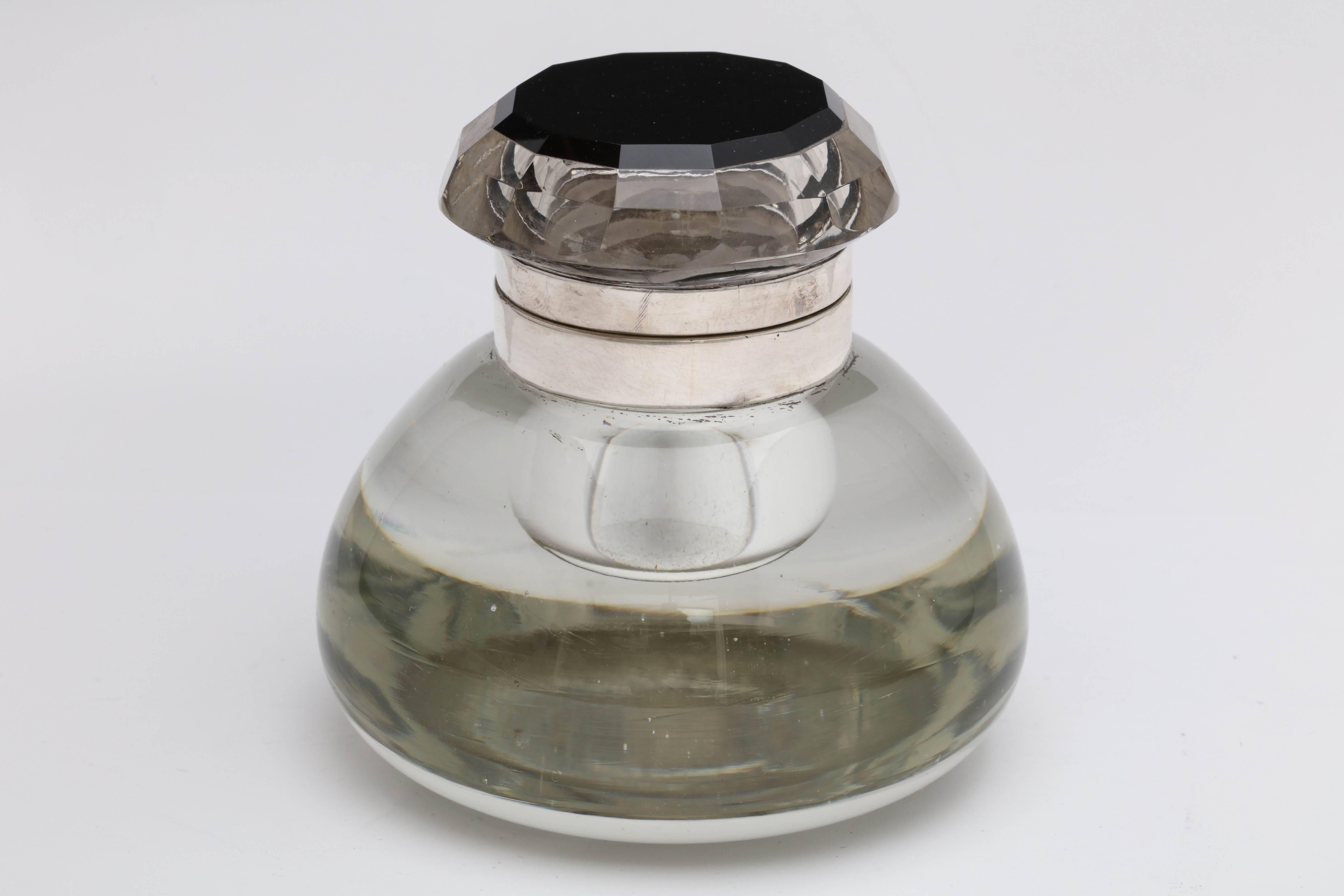 Unusual, sterling silver and black onyx-mounted hinged crystal inkwell, American, circa 1920s-1930s. 12-sided, faceted, clear crystal lid is mounted by a 12-sided piece of black onyx. Underside of lid and rim mount are sterling silver. Measures 3