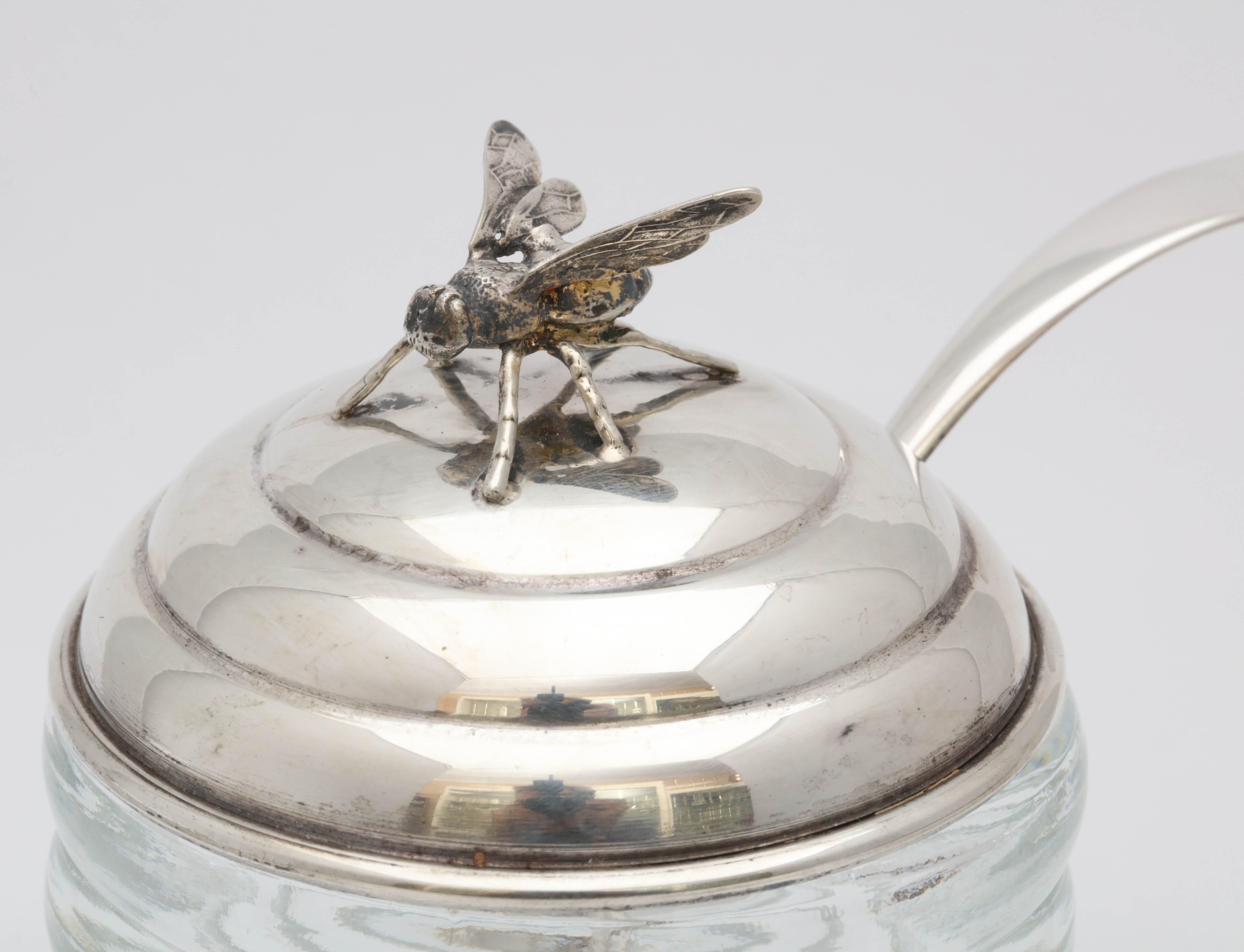 Unusual, Art Deco, sterling silver, mounted honey jar with original spoon, R. Blackinton and Co., No. Attleboro, Mass, circa 1930s. Glass is beehive-form; sterling silver lid is topped by a honey bee. Measures: 4 1/2 inches high (to top of honeybee