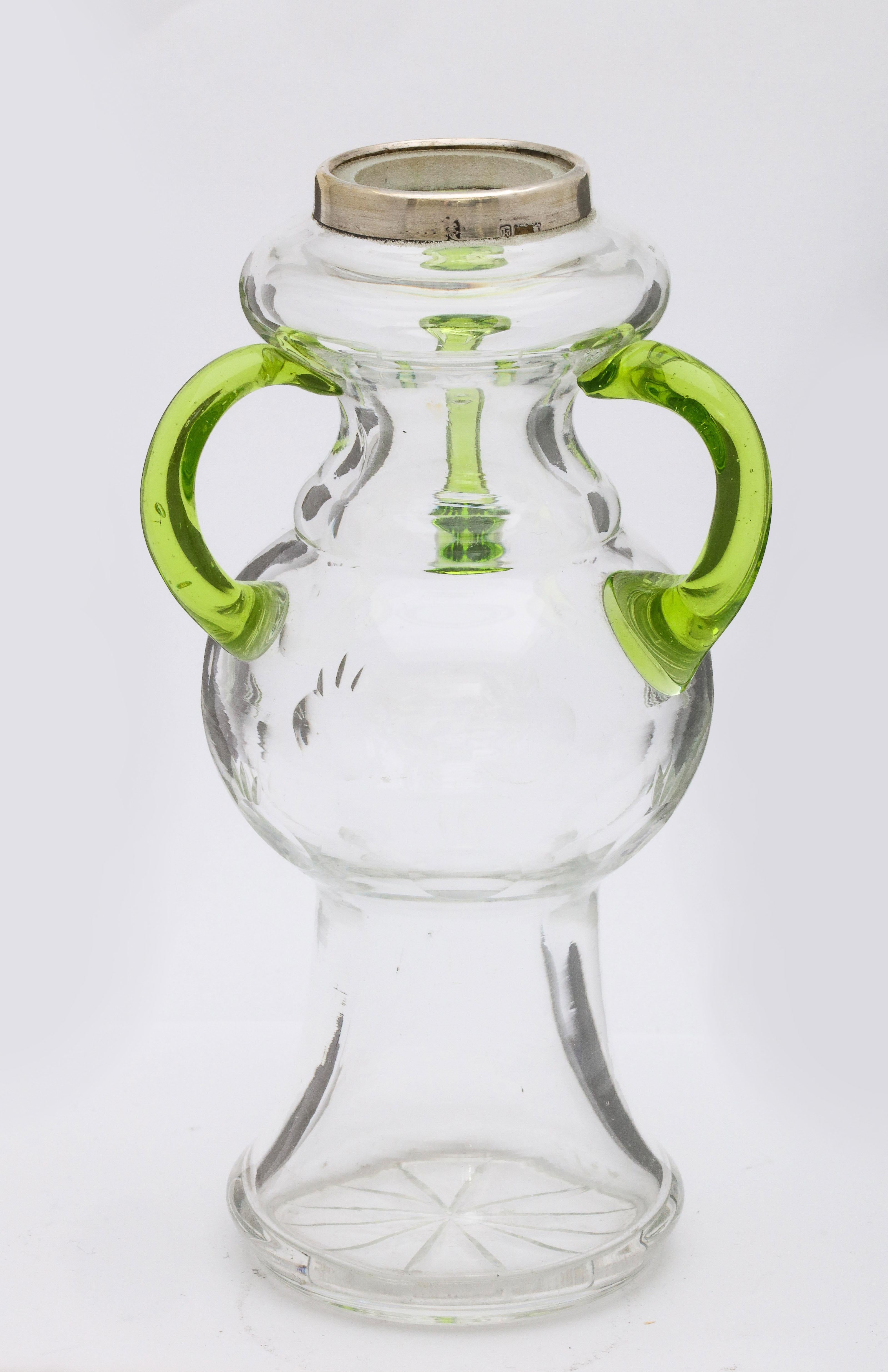 Unusual, Art Nouveau, sterling silver-mounted clear and lime green hand blown glass vase, having three lime green hand blown arms, London, 1905. Incised star on underside of base, small cut design on central part of vase (see photos). Measures: 6