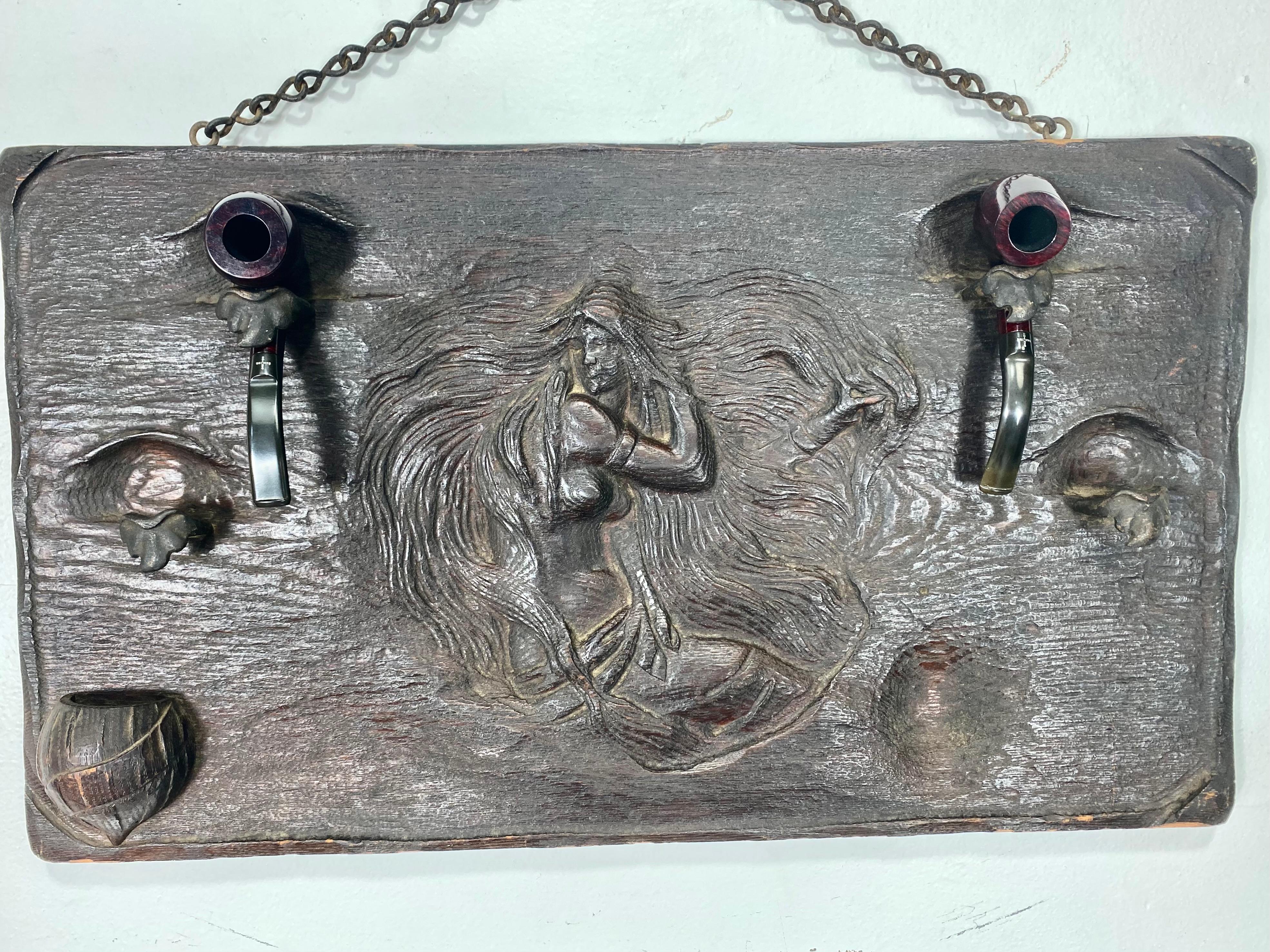 Unusual Art Nouveau woman, relief carved wood and metal pipe holder wall plaque. Stunning nude, wonderful detailing.., bronze mounted, hand forged pipe holders, carved wood match holder, retains original chain (hanging).