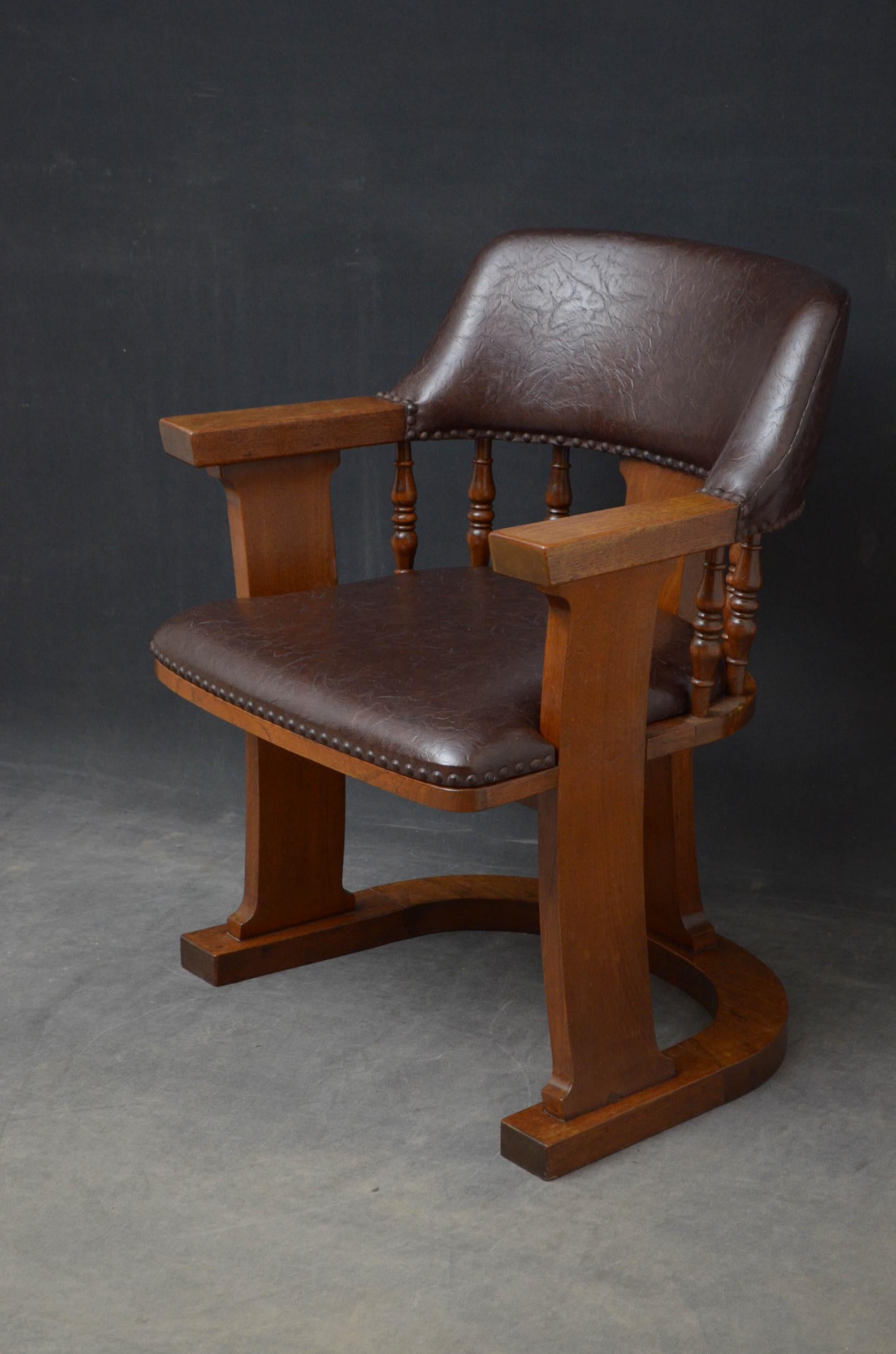 Sn4998 very unusual Arts & Crafts office chair in oak, having leather upholstered top rail above turned spindles and generous leather seat flanked by open arms terminating in substantial uprights, all united by U shaped supports. This antique chair