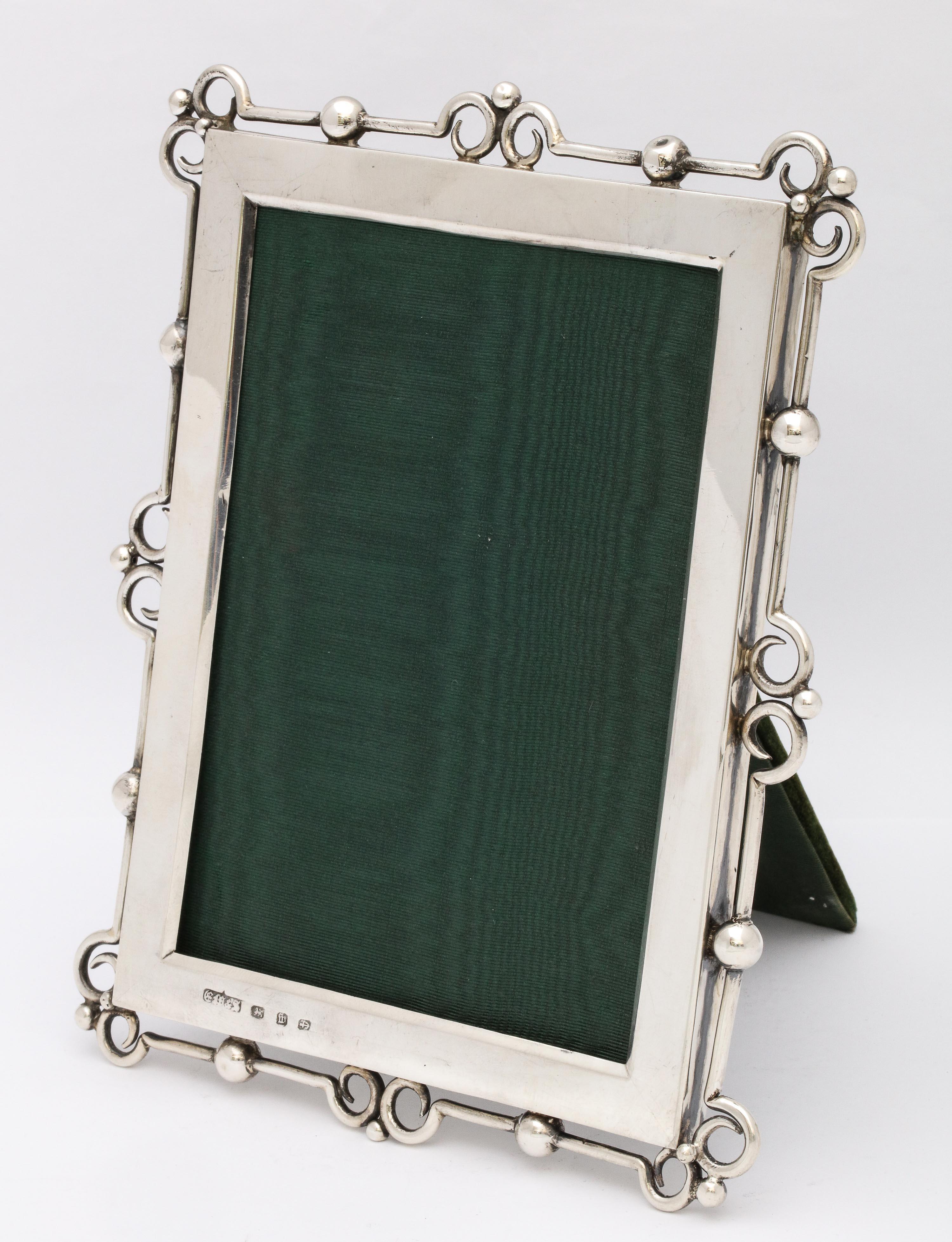 Unusual, Arts & Crafts, sterling silver picture frame, Birmingham, England, year hallmarked for 1896, E. Mander and Sons - makers. Velvet back. Measures: 7 1/4 inches high x 5 3/4 inches wide x 4 3/4 inches deep (when easel is in open position).