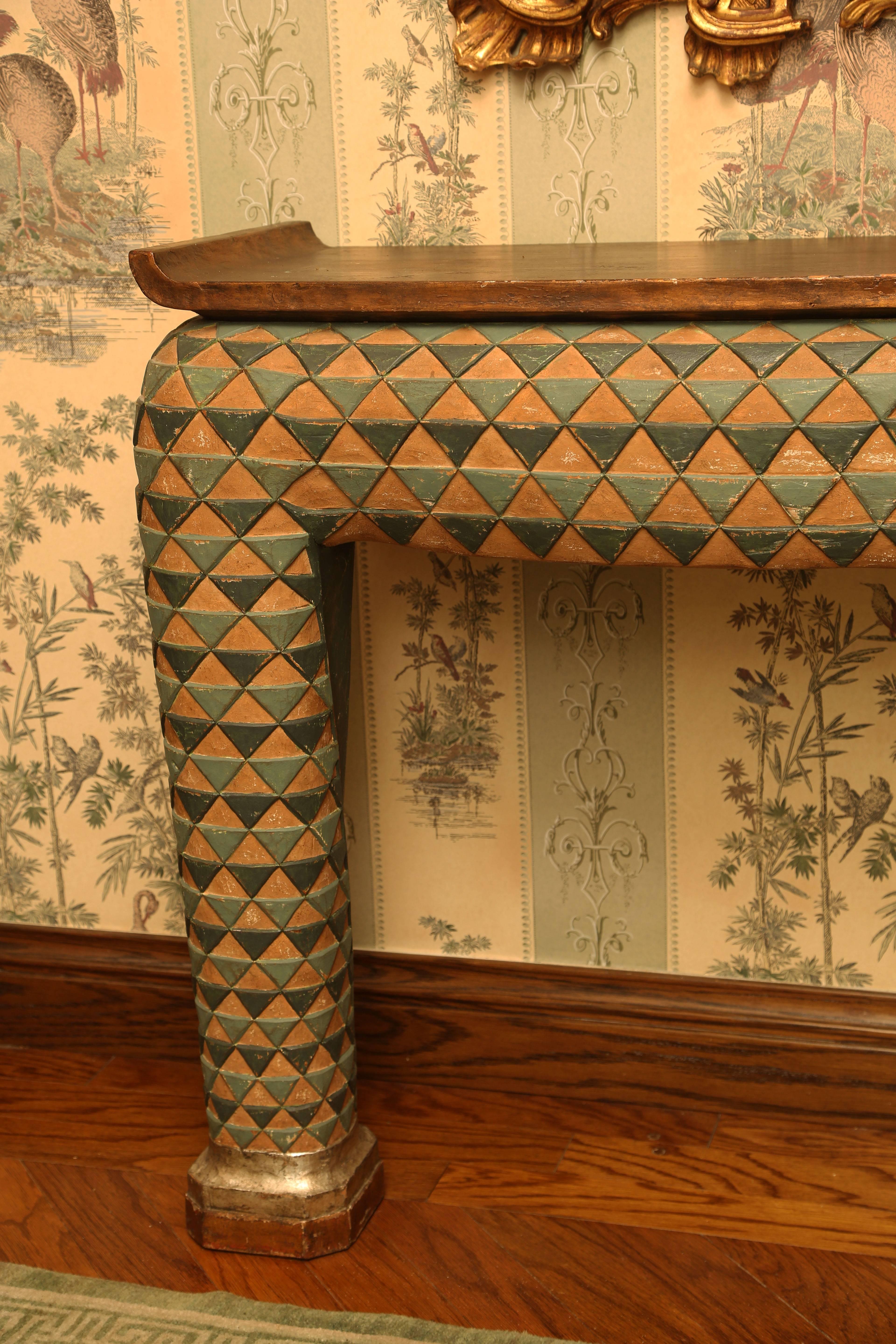 If one put Post-modernism and Asian influences in a blender, you would get this unusual console table. Riffing on an altar table form, the top with upturned ends painted a metallic copper (or could be read as an antiqued gold) color over the terra