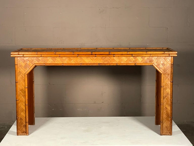 An interesting bamboo console table, ca' 1950's. Warm patina and elegant woven pattern make this a standout.