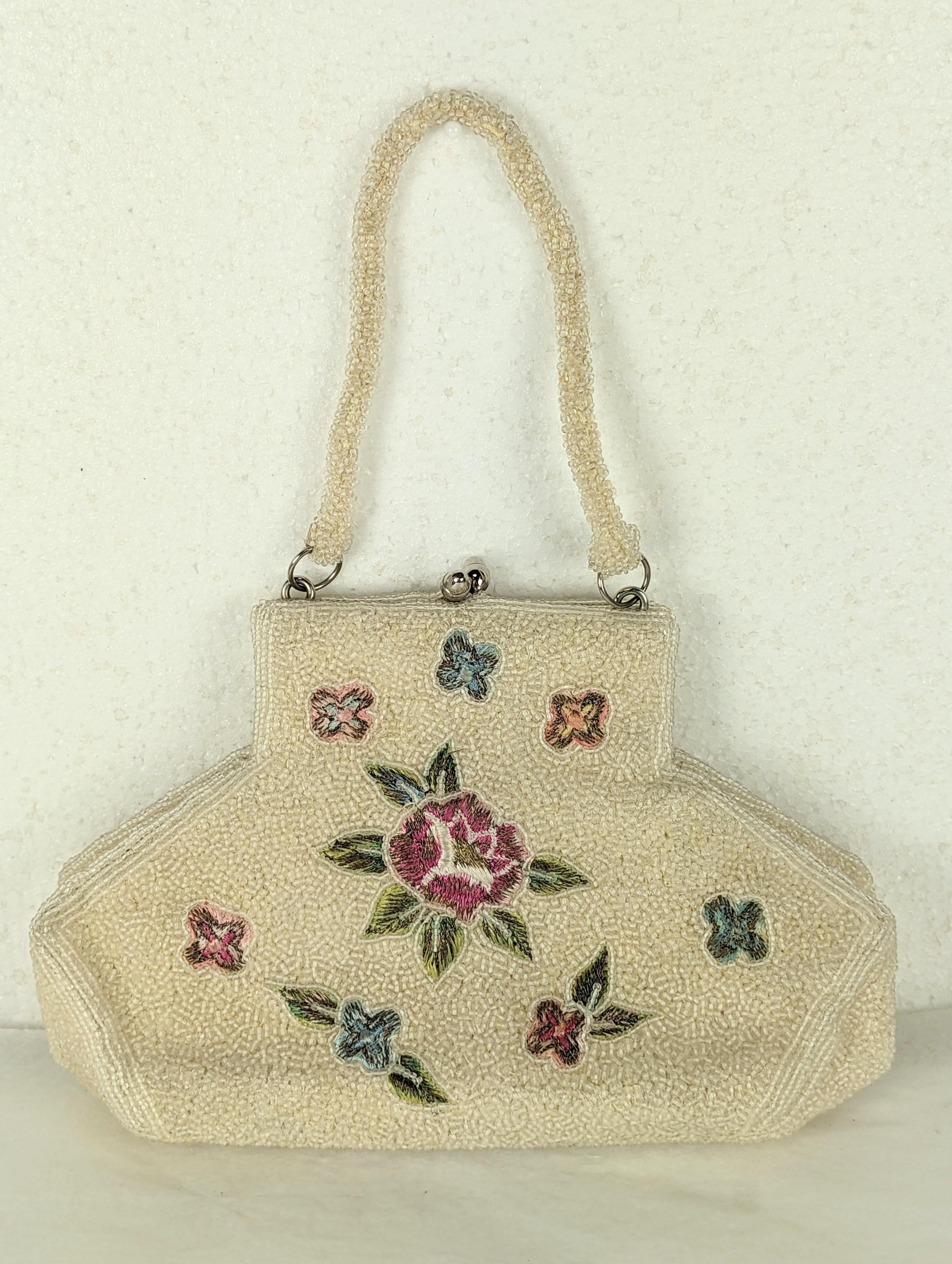 Unusual Beaded and Embroidered Bag by Charlet Bags. Flowers are hand embroidered with colored silk thread and metallic floss on a base of ivory seed beads. Shape is unusual but holds alot at bottom. 1950's Japan. 
8