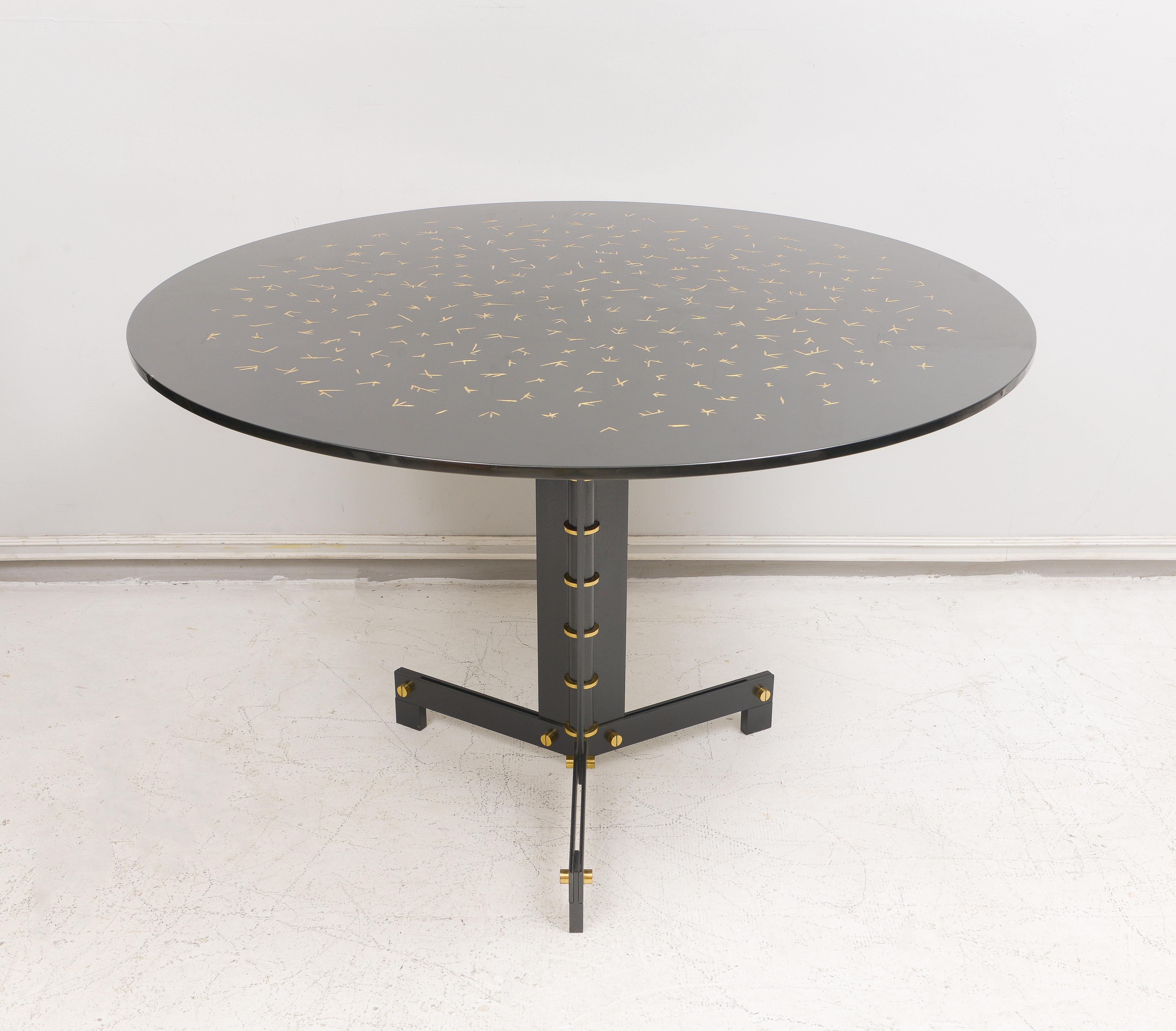 Ebonized circular table on steel and brass base with hand-incised gold-leafed lacquered top. Please note that this table can be customizable to your specifications with a lead time fo 8-10 weeks.