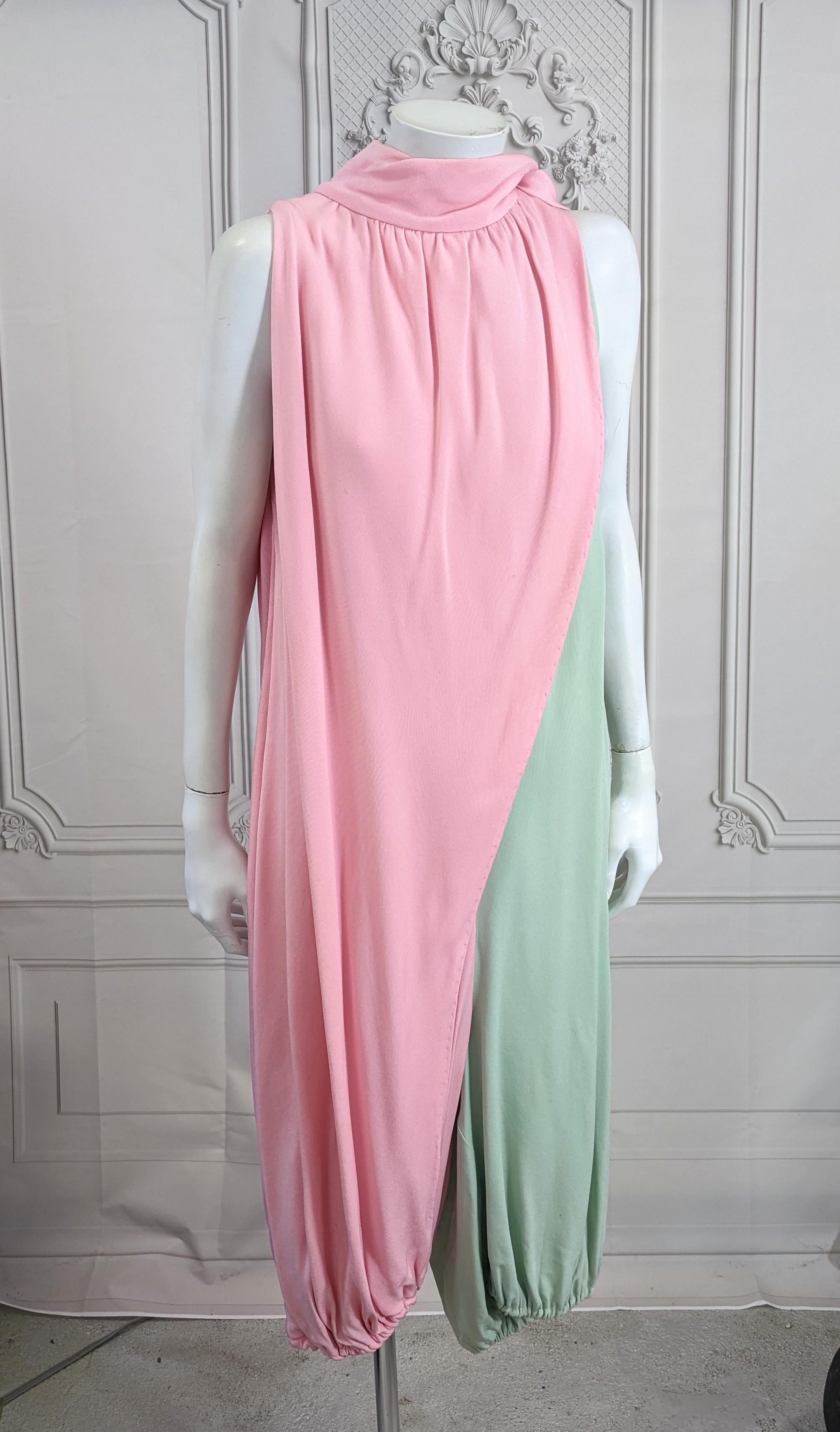Unusual Bill Blass Bicolor Crepe Balloon Jumpsuit from the 1960's designed for Maurice Rentner. 
Heavy silk blend crepe in sherbert pink and mint which wraps and ties at shoulder with a scarf neckline. Pink and green sections are bisected down front