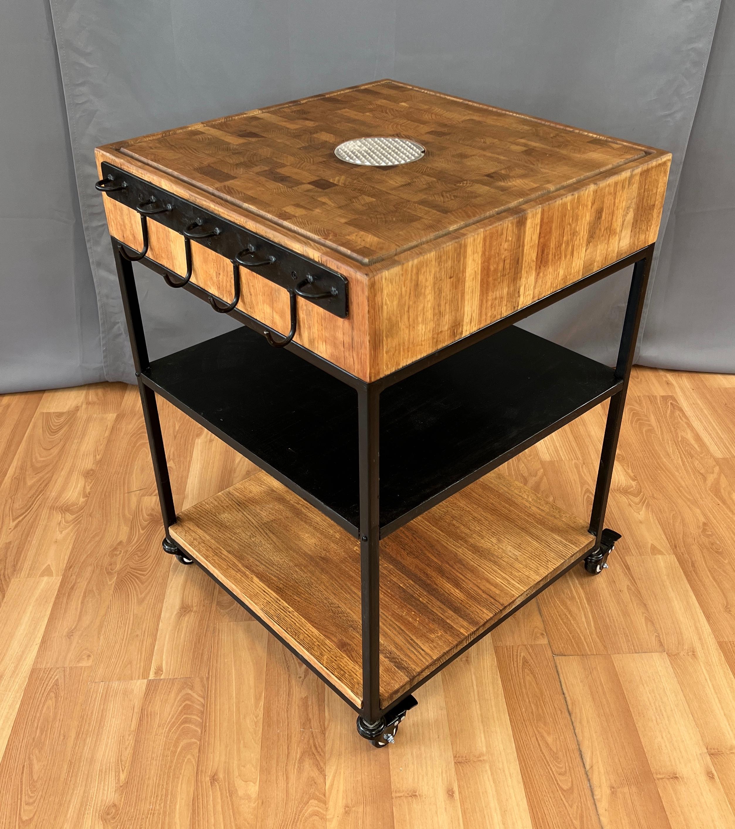 An unusual and unique Bill W. Sanders design, a large oak chopping block cart, on four wheels.
Large block of Oak, center has a round aluminum meat holder that's removable to clean underneath.
Near the outside rim has a carved groove to catch the