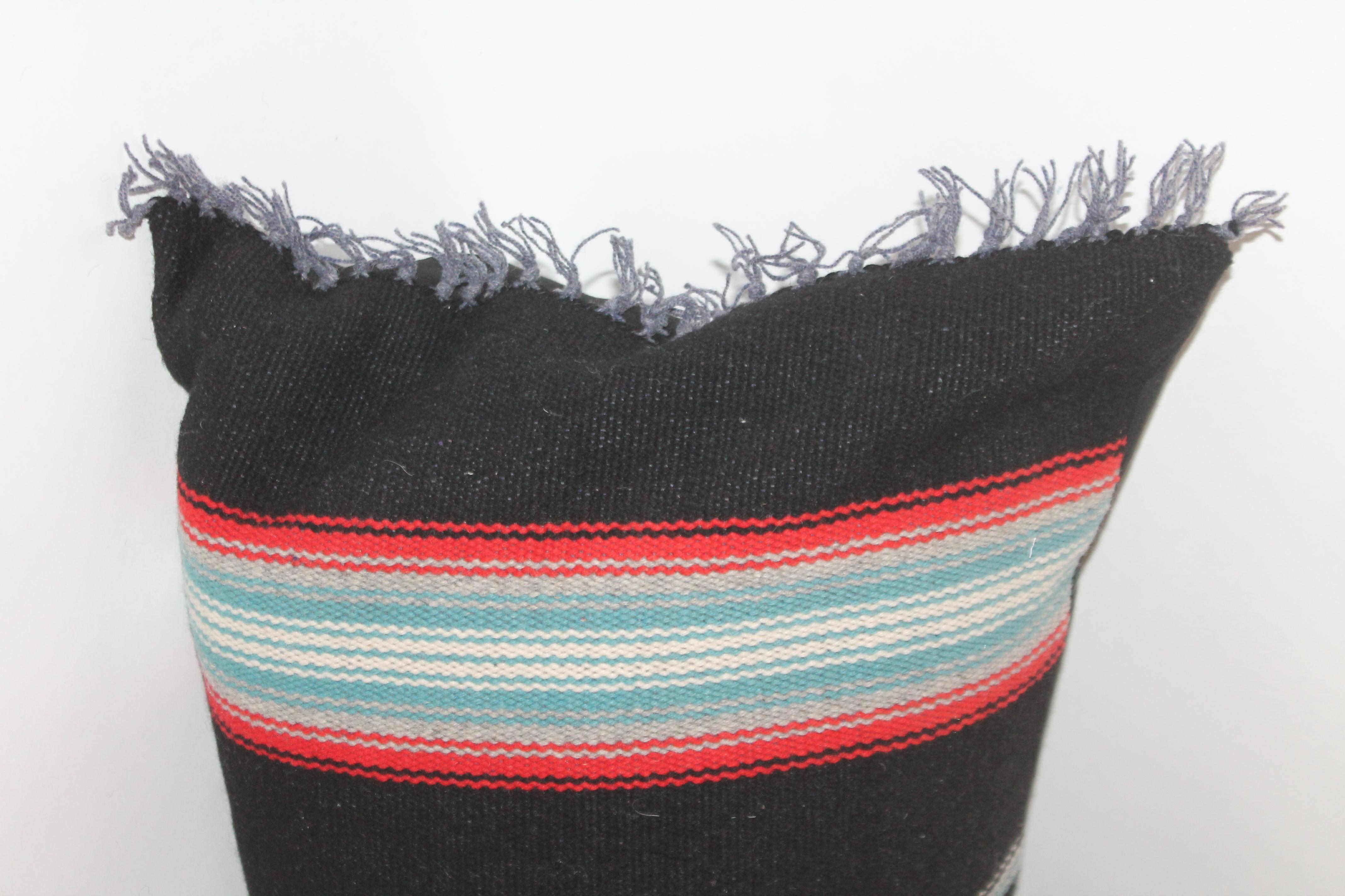 Beautiful patterned black and red eye dazzler pillow with black linen backing.