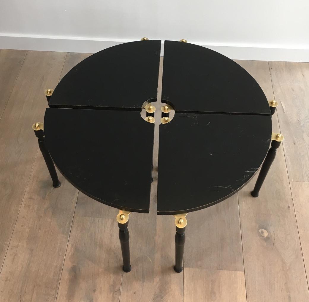 This unusual black wood and brass coffee table is divided in 4 quarters that can be used as side tables or assembled in a coffee table. This is a French work, circa 1970.