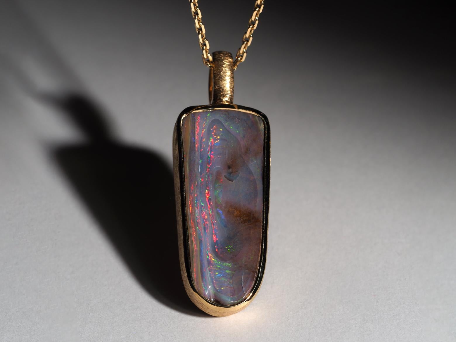 Silver necklace with natural unusual Boulder Opal in a shield shape (18K gold plated)
gemstone origin - Australia
gem size is 0.47 x 1.10 in / 12 x 28 mm
stone weight - 20.20 ct
pendant length - 1.54 in / 39 mm
pendant weight - 7.2 grams

The