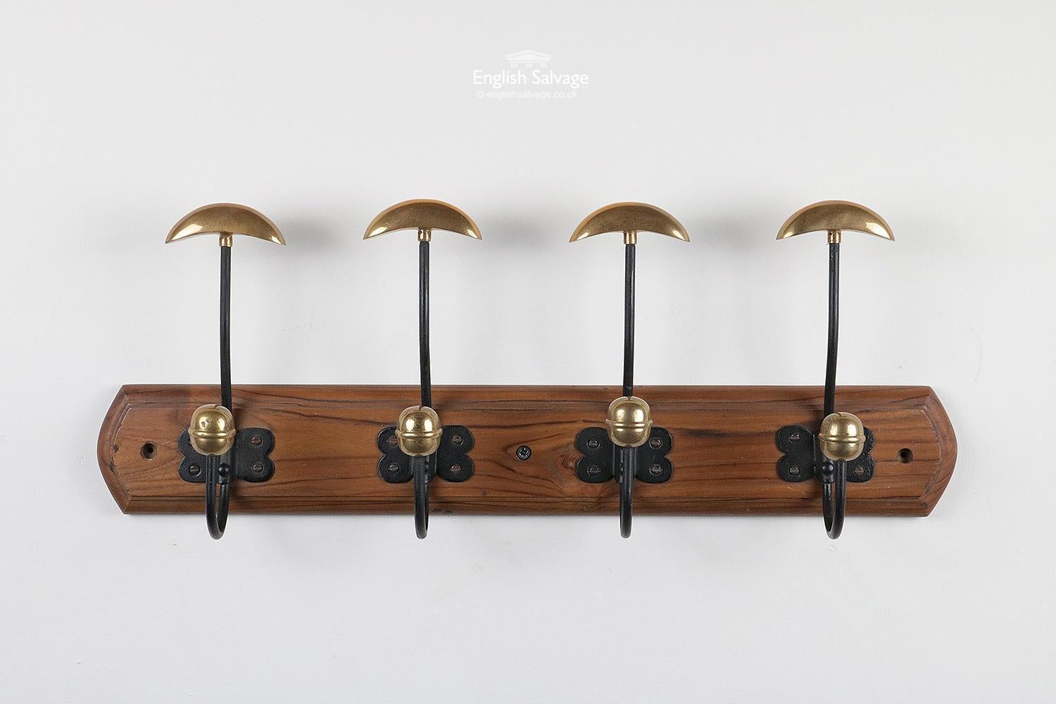 Attractive and unusual bowler hat and coat hook. Four iron and polished brass hooks on a shaped pine back board. Measurements given are the maximum overall. The back board itself is 55.6cm wide x 8.5cm high. Has three pre-drilled fixing holes.