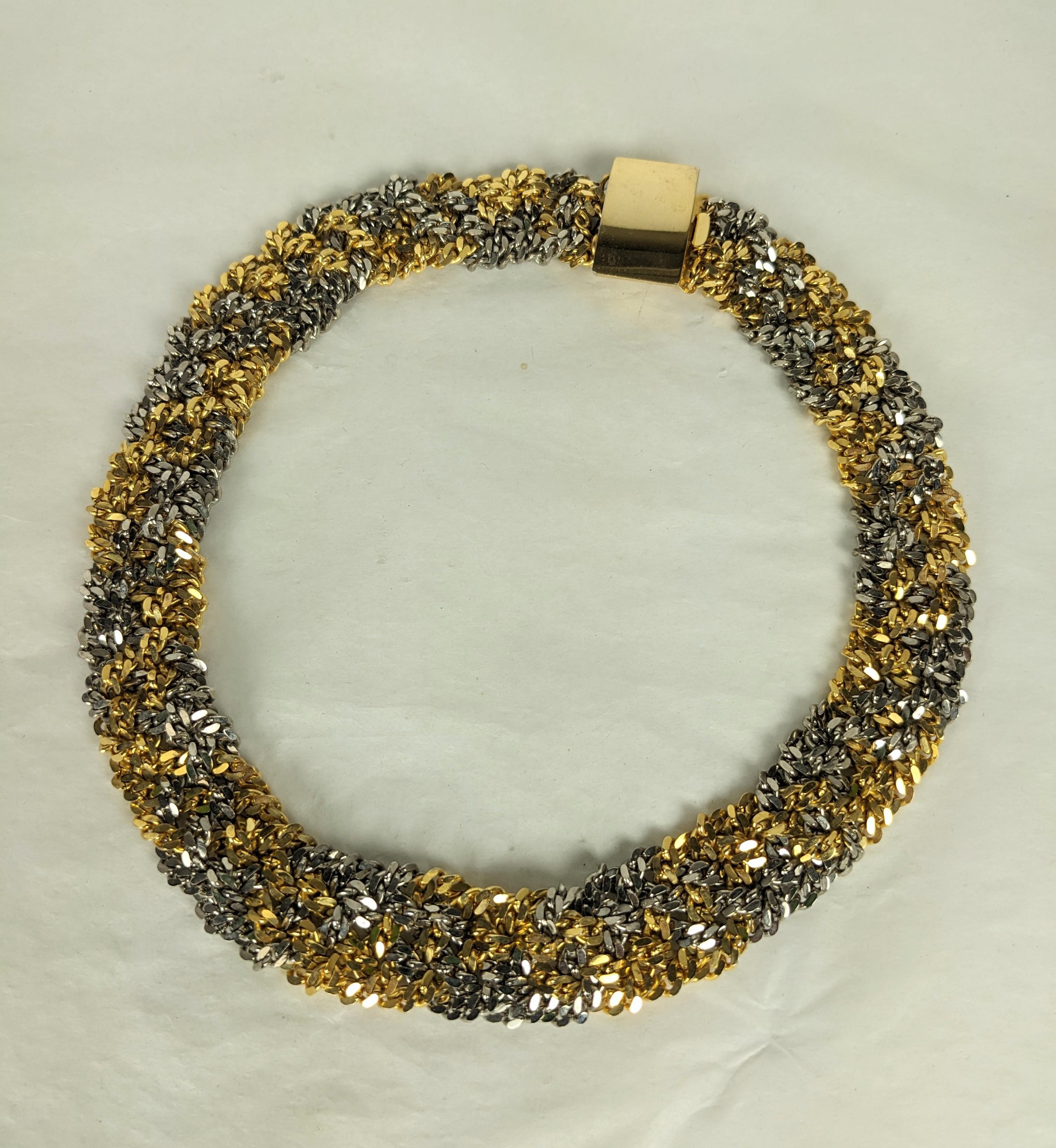 Unusual Braided 2 Tone Chain Necklace from the 1980's. Bright cut chain in gold and platinum tones is tightly braided to form a shaped necklace with gilt clasp. The effect is extremely unusual and different. Approx 17
