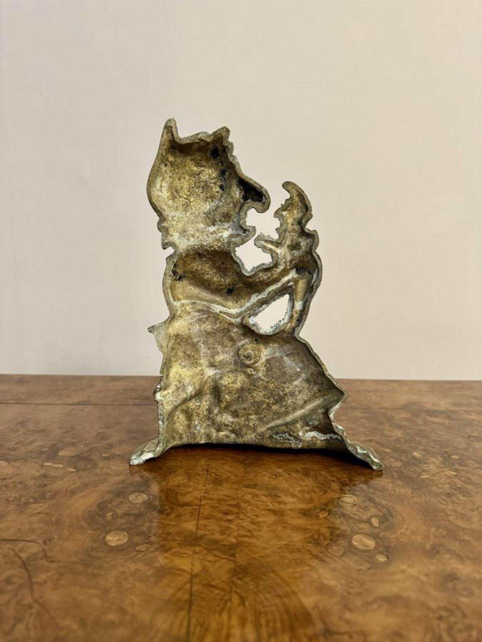 Unusual brass antique doorstop of Mrs Punch, having an unusual antique brass doorstop of Mrs Punch holding 'The Babe' on her knee, raised on a brass shaped base. 

D. 1900