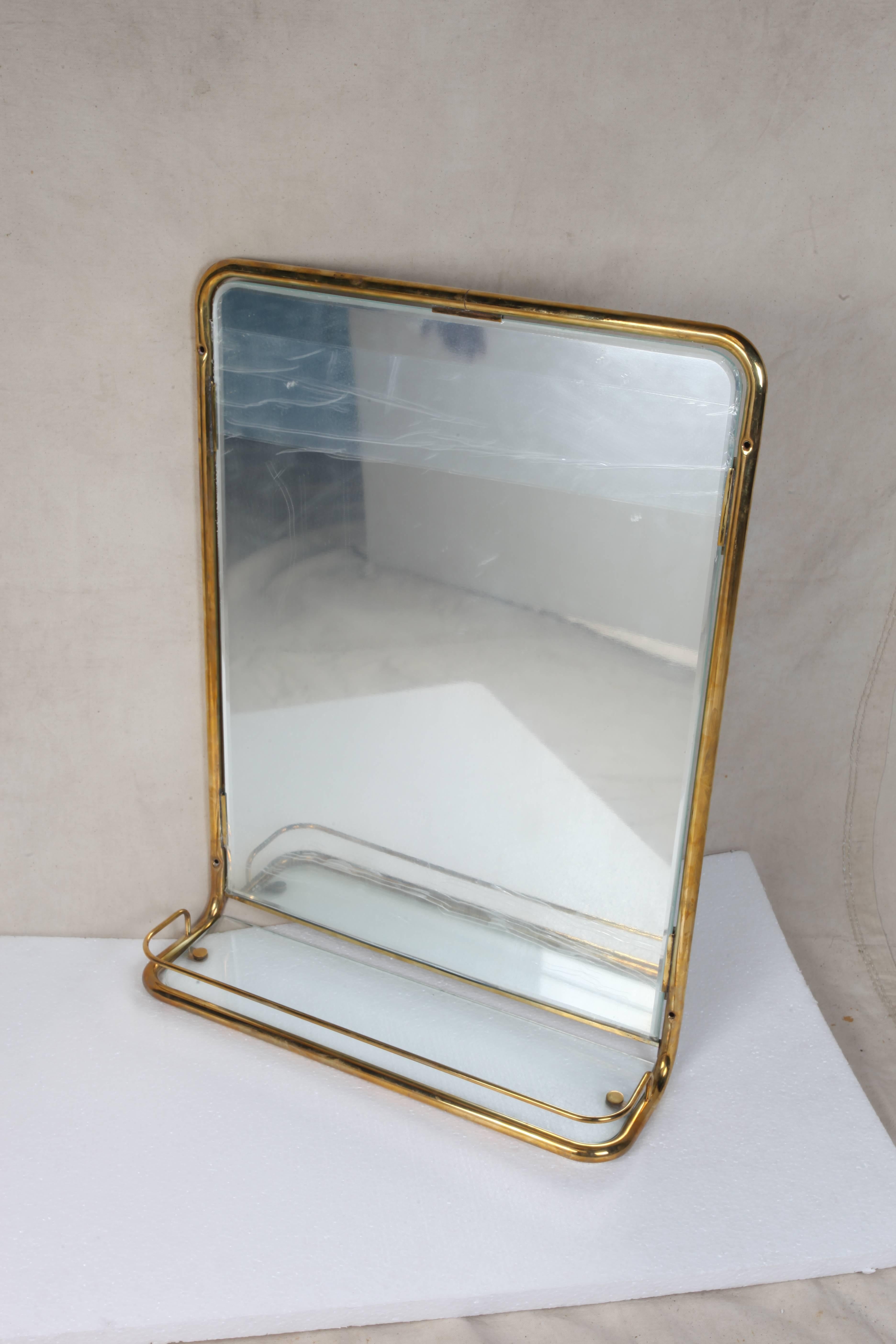 A great brass wall mirror from the stateroom of a decommissioned cruise ship. Features a new mirror and glass shelf with the original brass railing around it, circa 1960s. As of this writing I have three pieces.

Nautical antiques on nantucket