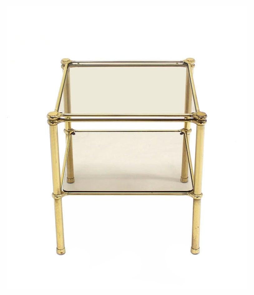 Mid-Century Italian modern brass side or end table stand with smoked glass shelves.
Inspected vintage condition.