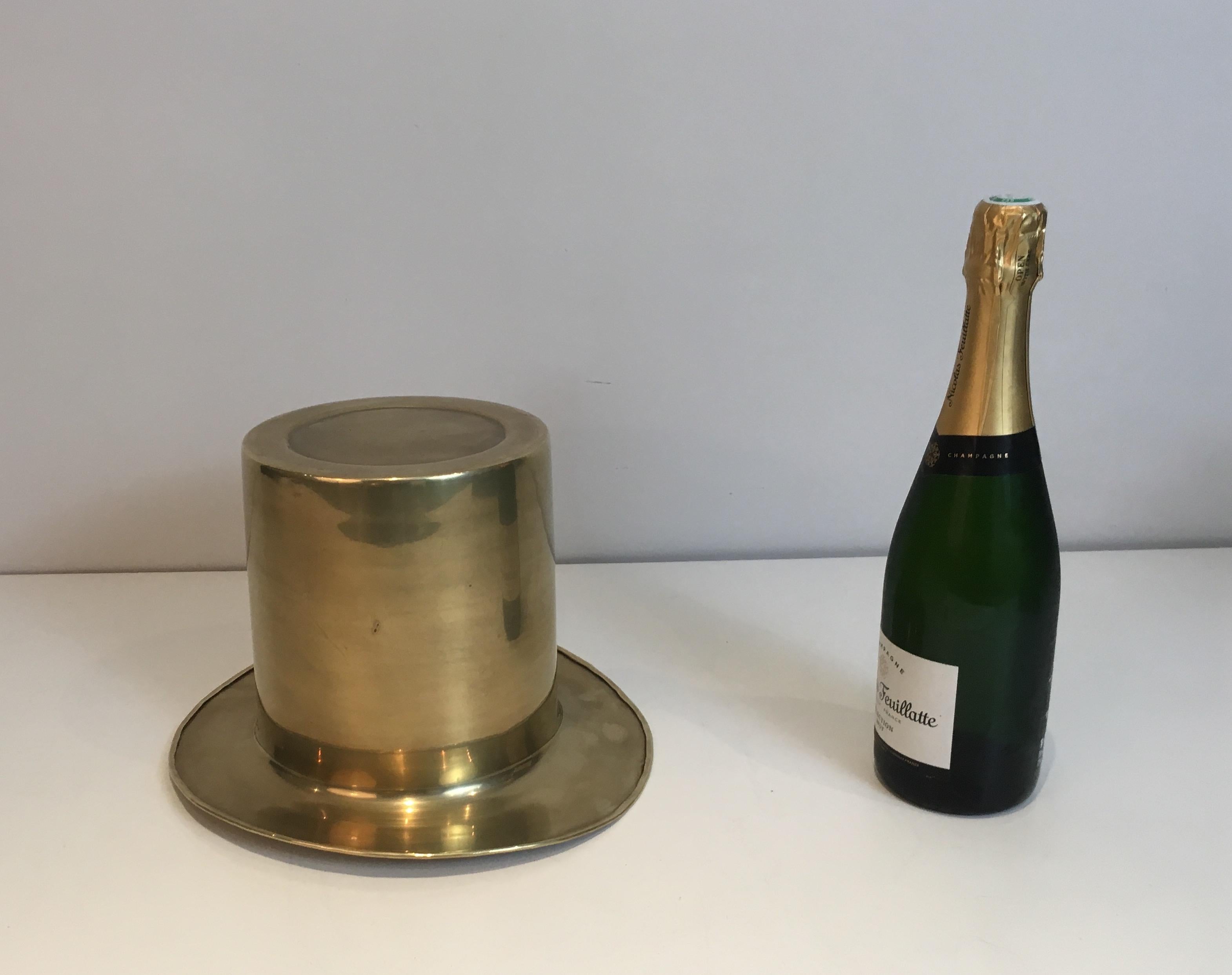 This unusual and decorative top hat champagne bucket is all made of brass. This is a French work, circa 1920.