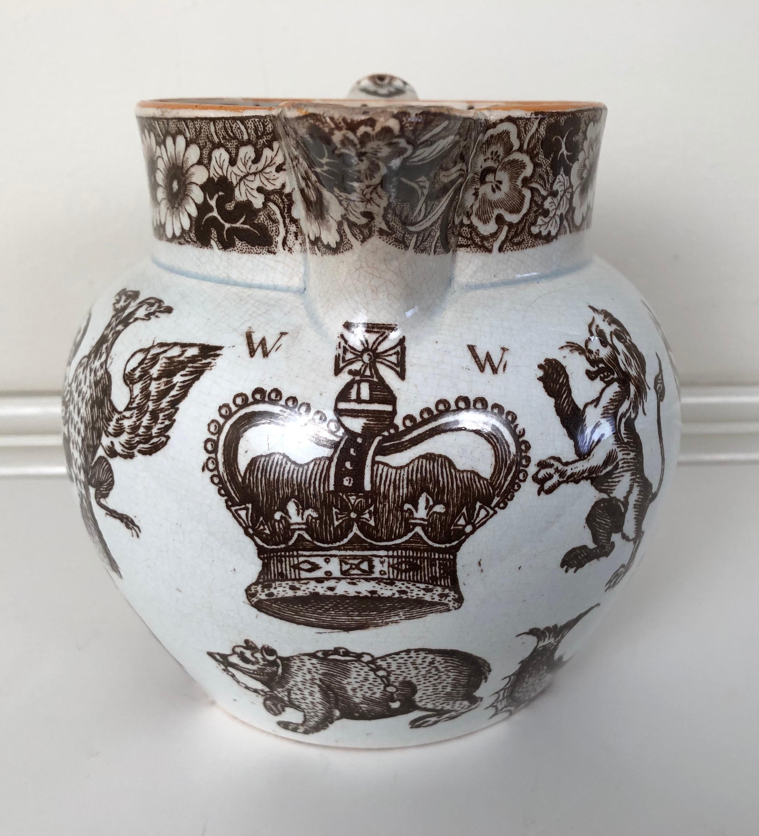 A 19th century Staffordshire pottery brown transferware pitcher with an unusual variety of motifs, inside and out, including a sheaf of wheat, crown, lion rampant, dolphin, imperial double-headed eagle, angel, sea shell, boar, with a stag printed on