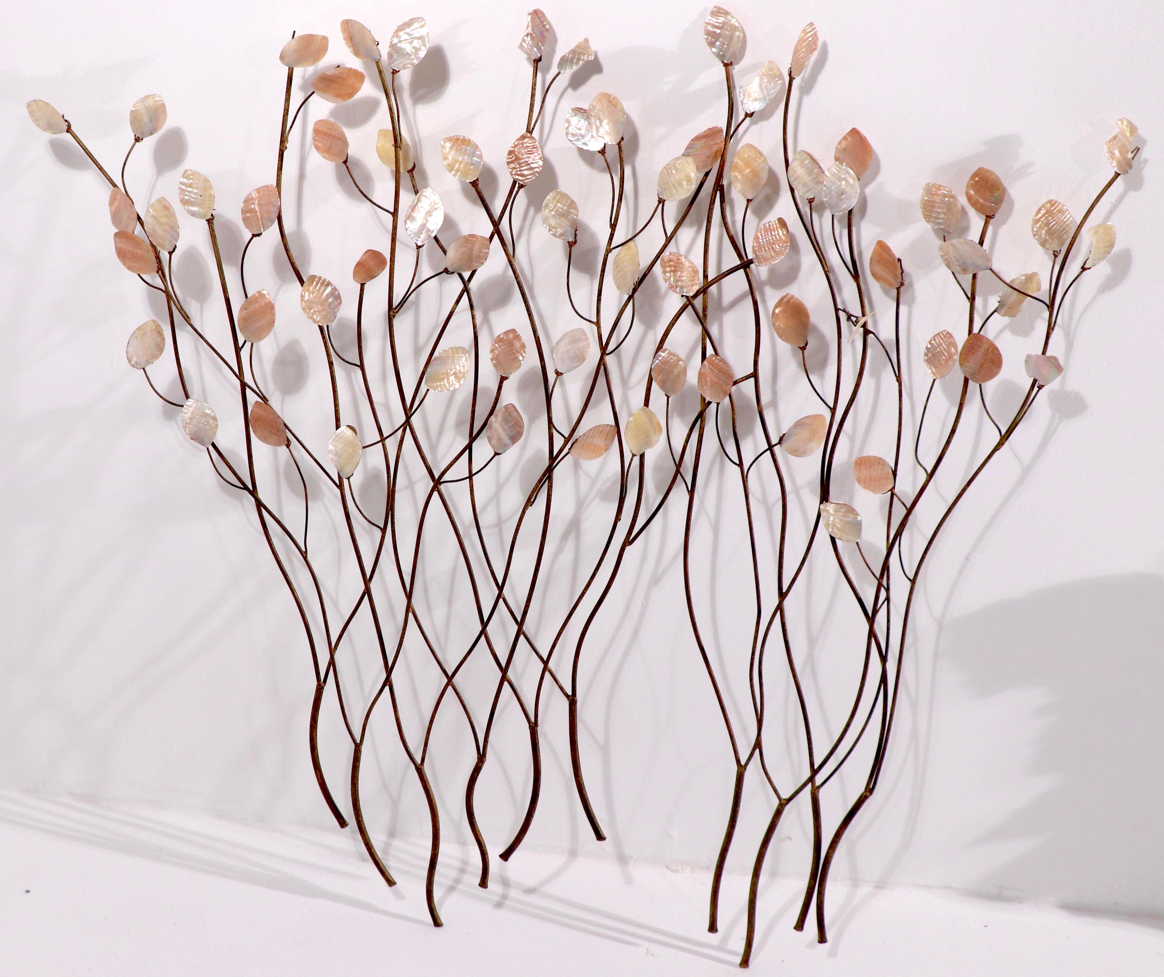 Unusual Brutalist wall sculpture, having wrought iron trees, and Mother of Pearl shell leaves. The sculpture is in good original condition, some leaves show chips, and loss, please see images. This item is attributed to Curtis Jere, it is unsigned.