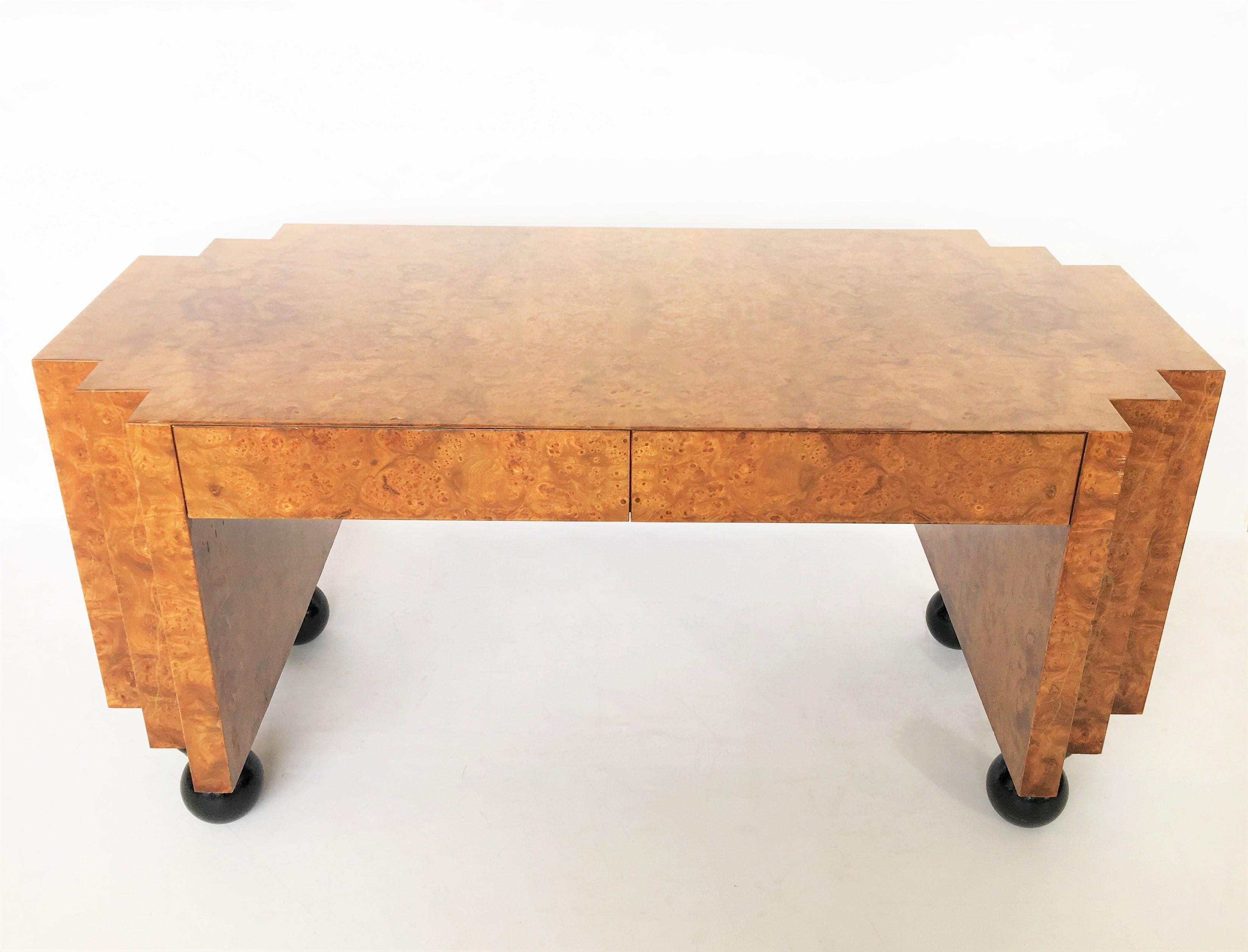 This gorgeous unusual burl wood desk in the style of Milo Baughman. With black lacquer legs Featuring two drawers.
