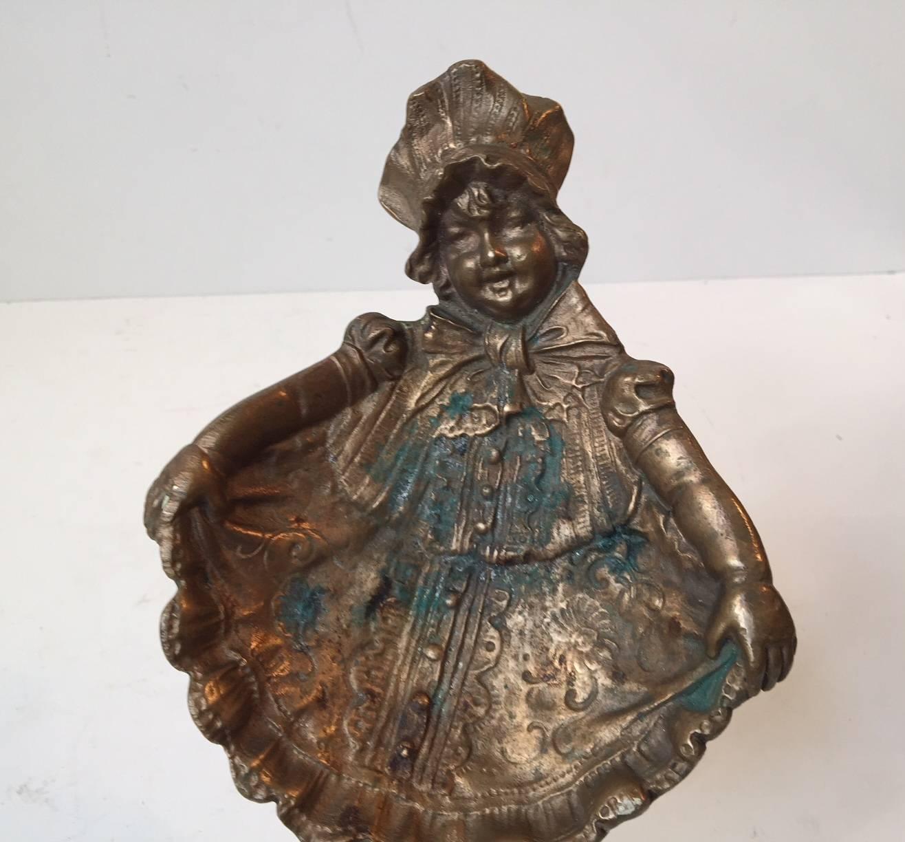 Detailed wall plaque or ashtray in shape of a dressed up little girl. Manufactured in Denmark during the 1920s. Stamped - Bronce to the backside.