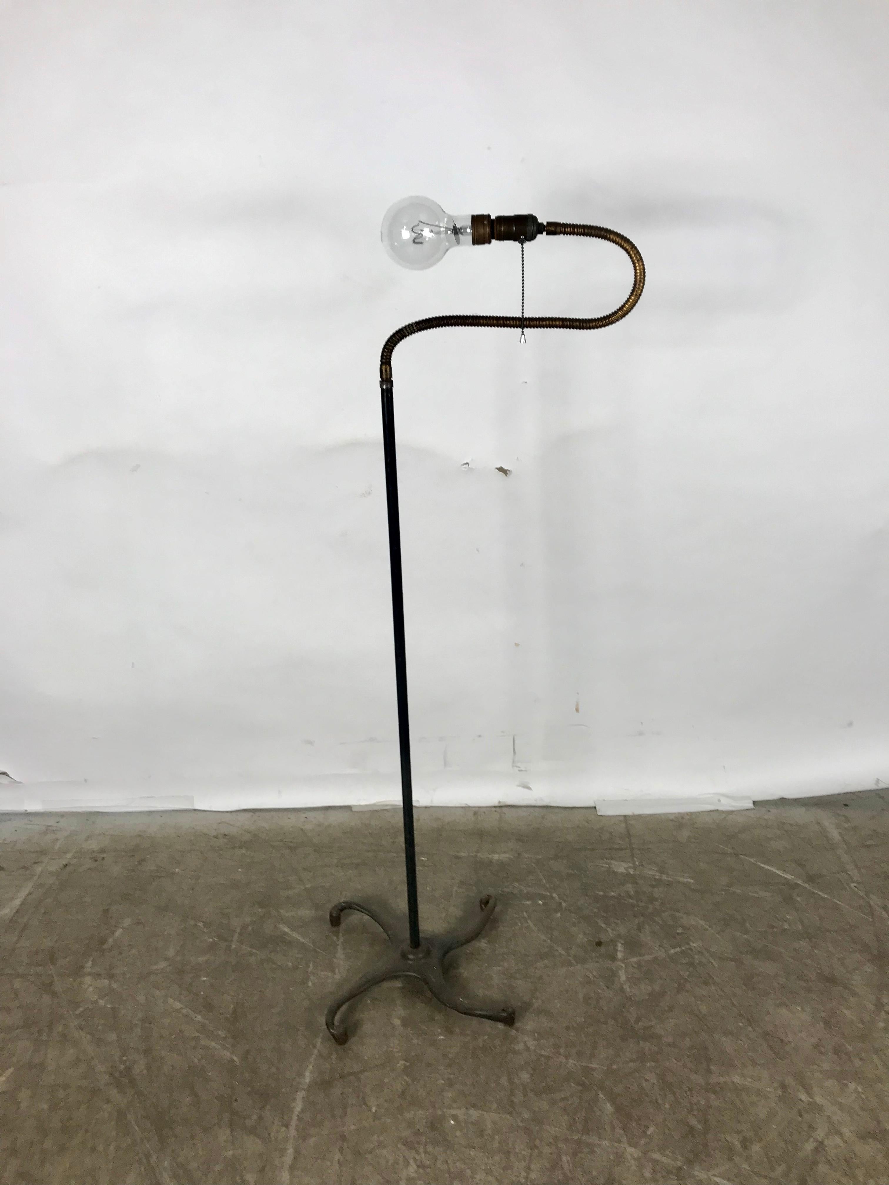 Unusual cast iron and brass goose-neck industrial floor lamp by Hendryx, fully adjustable, bendable. Amazing designed 1920s serpent like base.