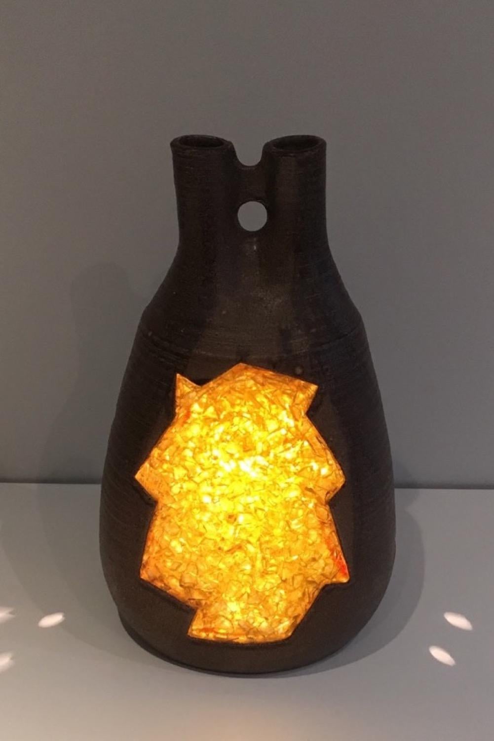 This unusual lamp is made of ceramic and yellow glass. This is a French work, circa 1970.
