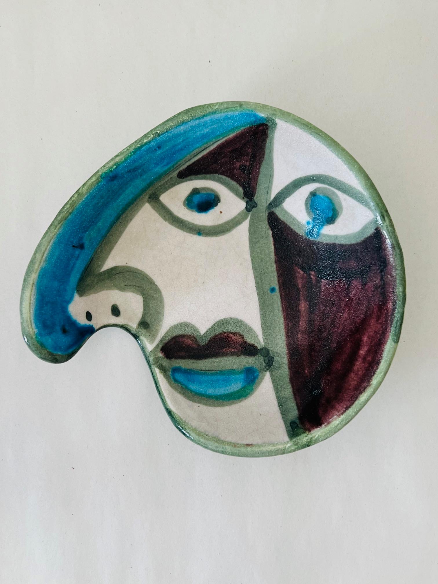 Unusual bowl By Gambone, depicting an anamorphic face. Typical period glazing and crackling. Signed on the bottom with the donkey mark.